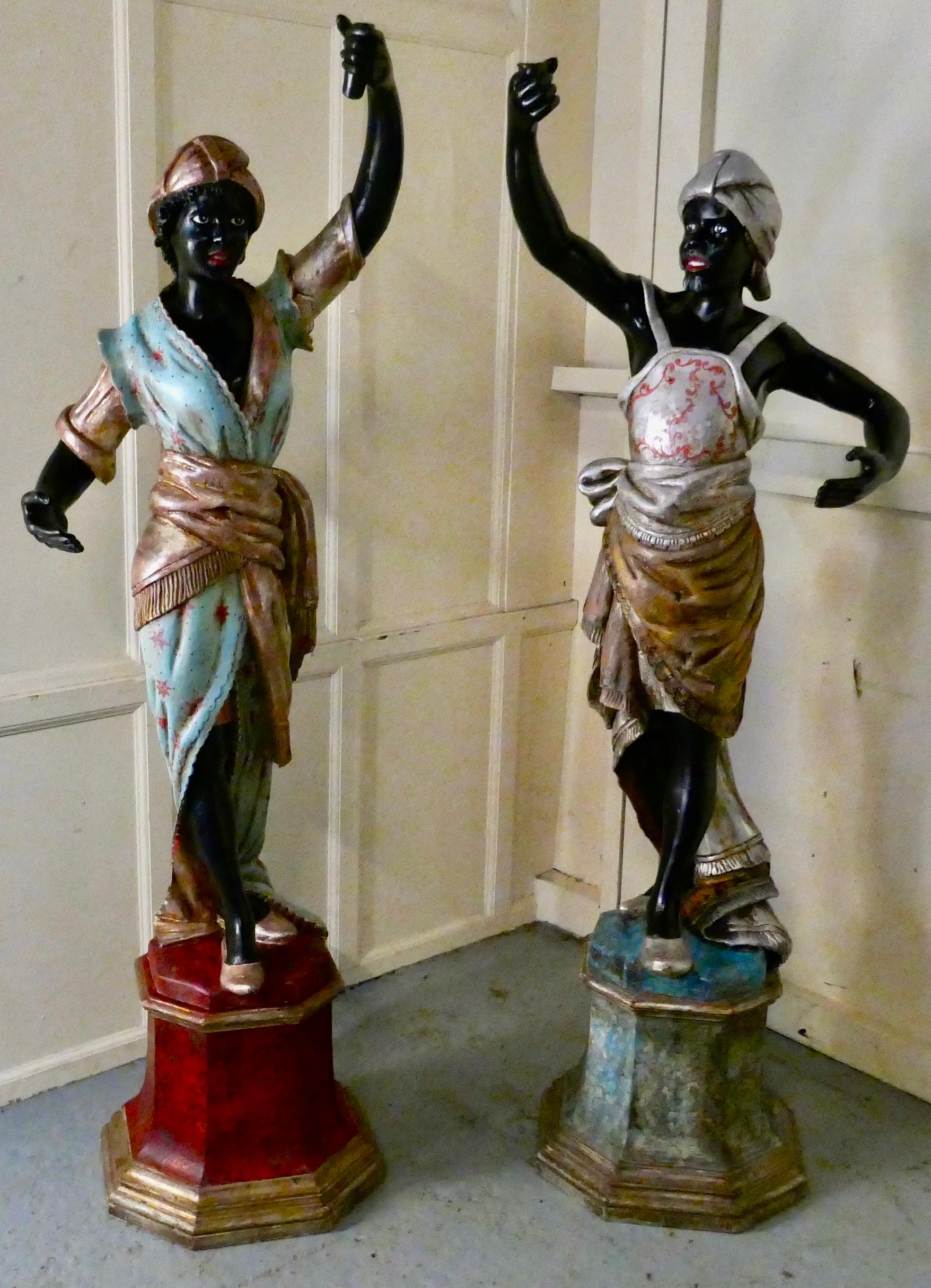 Pair of 19th century male and female Italian carved figures

This charming pair of figures stand almost 6ft high, they each have a socket in their hand which once would have held a candle sconce.
They are extravagantly dressed, him with his neat