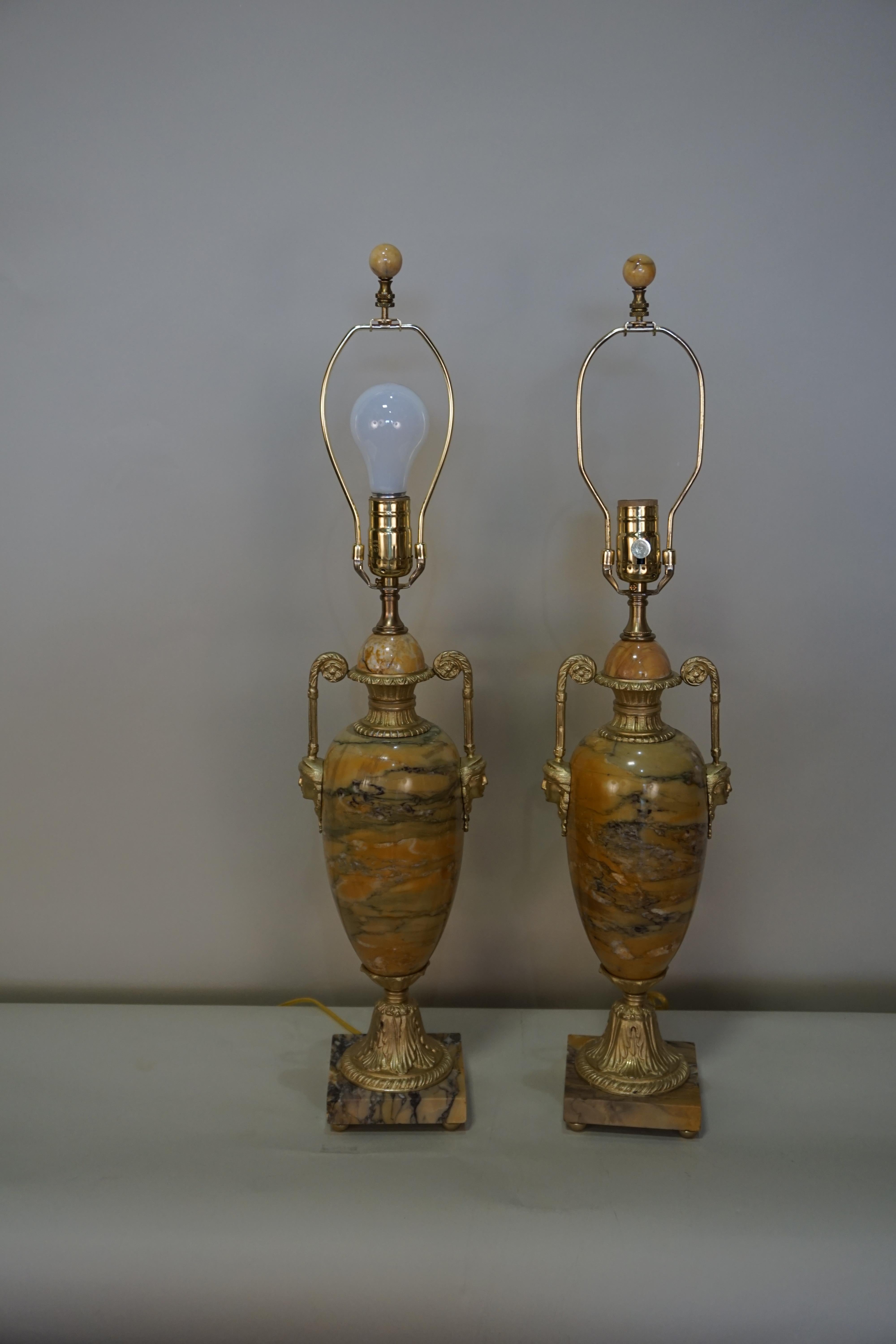 Pair of Empire style electrified marble and bronze table lamps.
Fitted with box pleat silk lampshades.