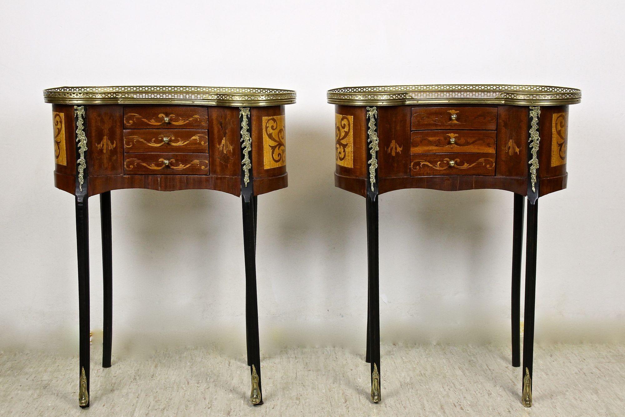 Lovely pair of 19th century French marquetry side tables from the period around 1880. Made of fine mahogany wood, these Louis XVI styled side tables show a very elegant design. The beautiful kidney shaped tables impress with elaborately made