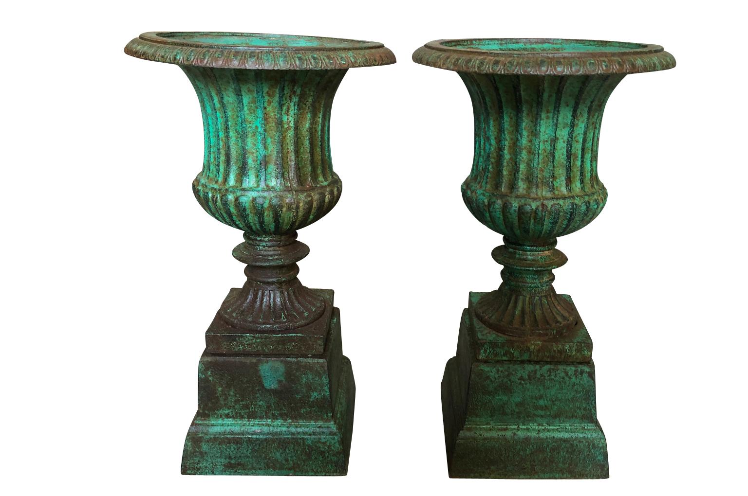 A wonderful pair of 19th century Medici style urns from Galicia, Spain. Wonderfully cast in iron with the wonderful painted finish. Perfect for any interior or garden.