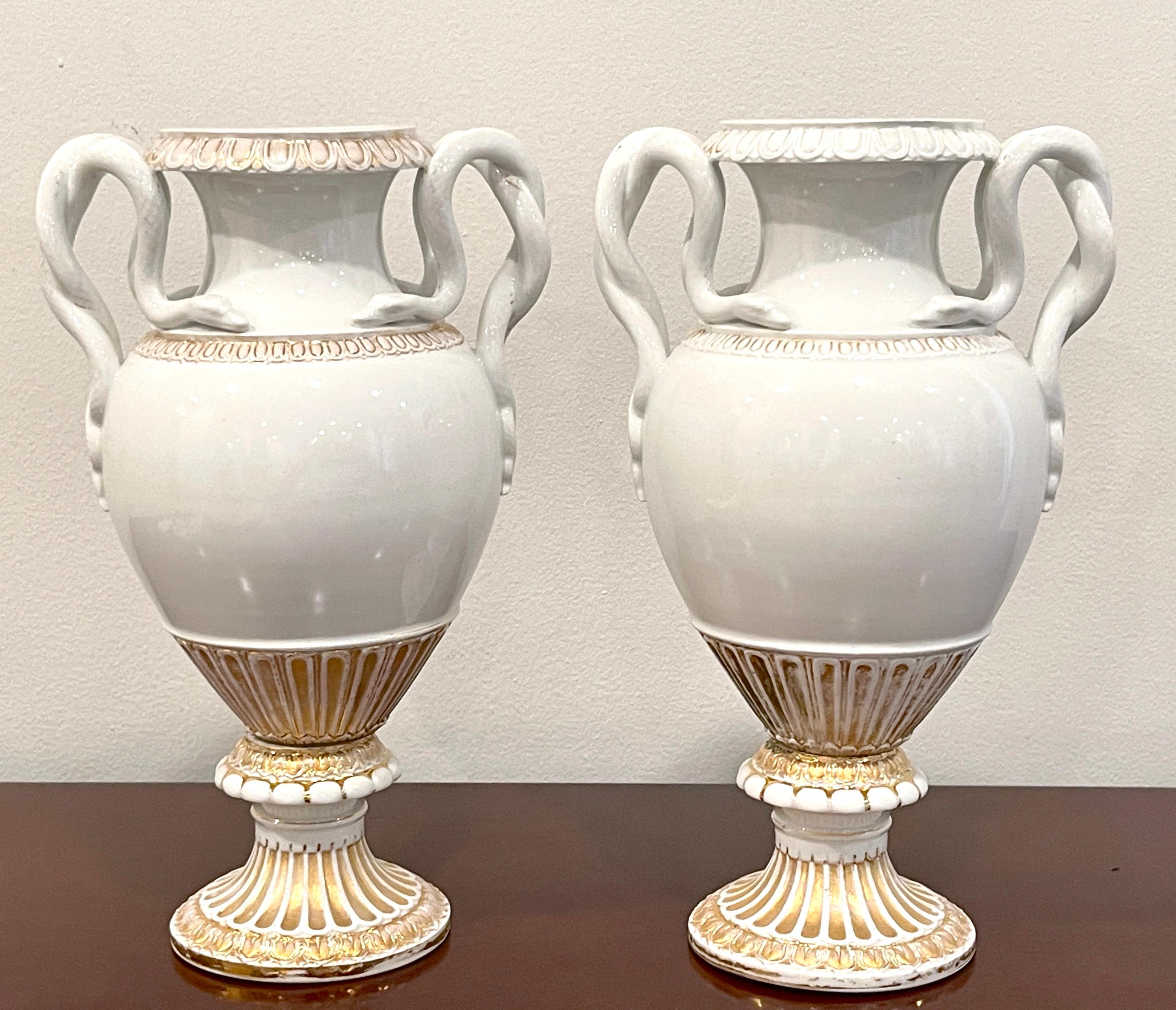 Pair of 19th Century Meissen gold & white neoclassical serpent handled vases.
Germany, circa 1880s
Design attributed to E.A. Leuteritz 

Hard to find a pair of understated Meissen neoclassical urns, each one with intertwined serpent handles,