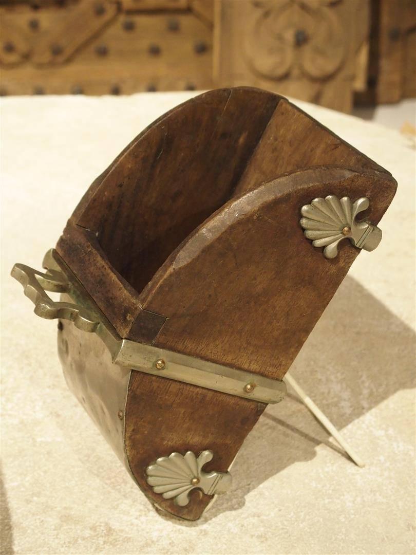 These wonderful Portuguese wood and hand shaped metal stirrups date to the early to mid-19th century. They have ornamentation of two metal palmettes on the wooden sides. This style of armored stirrup is typical of Portugal and has been in use since