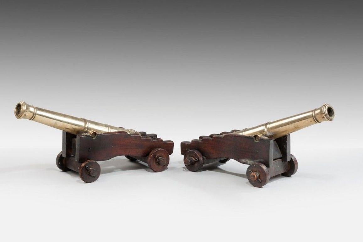 Pair of 19th century model cannon with tapering bronze barrels on original mahogany carriages.
  