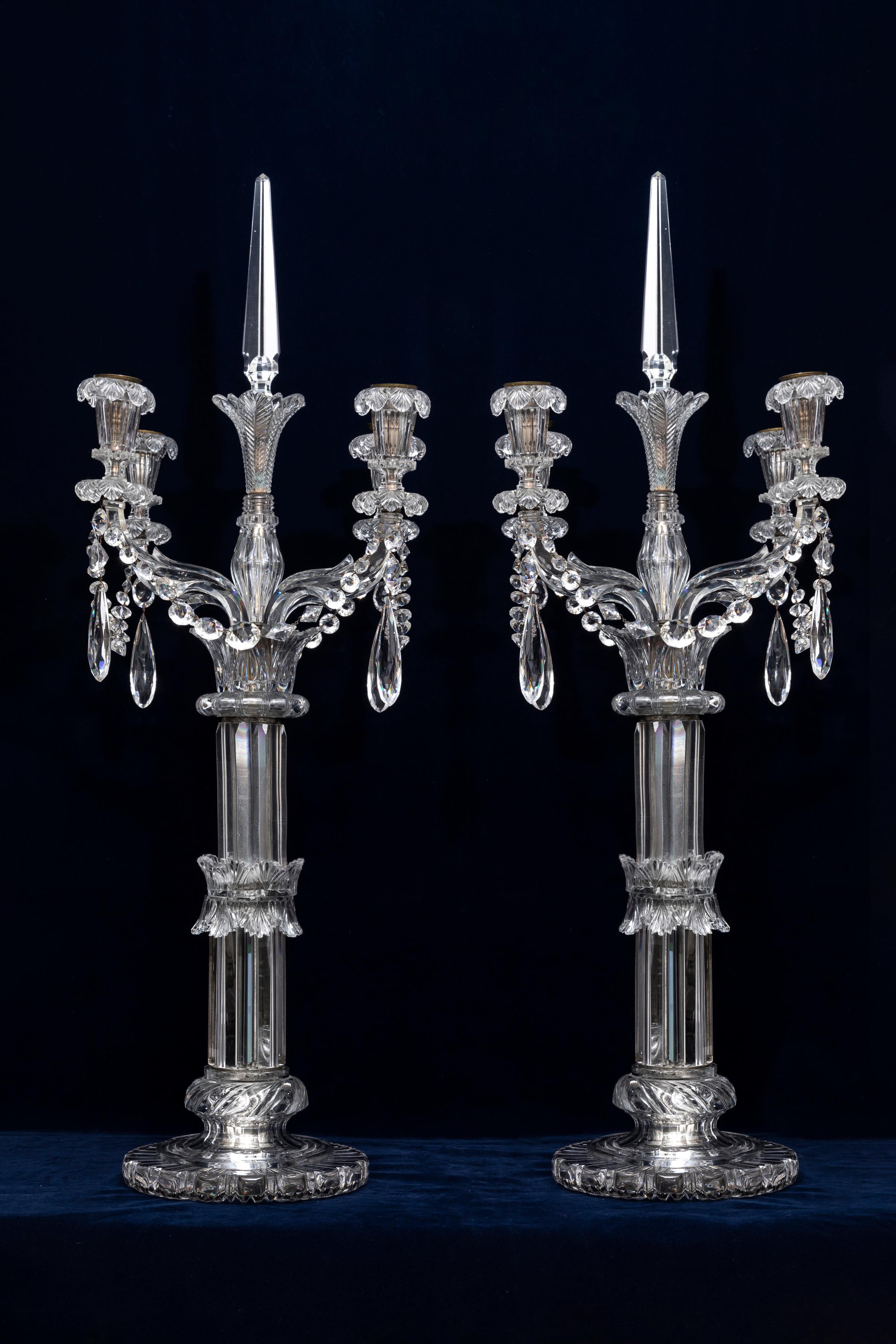 A Pair of 19th Century Monumental Palace Size Osler Four Light Crystal Torchères/Candelabras.  Each section is super finely hand-carved and hand-cut from the finest and most dense crystal of the time.  Each arm and the the finial prism are made up