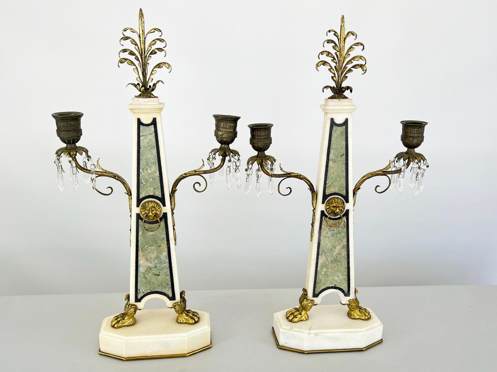 Pair of fine candelabra from the Napoleon III period. Each a tapered pilaster of white marble inlaid with verte and noir stone, set upon an octagonal, graduated plinth. A gilt-bronze lion's mask and ring decorate the center of each column,