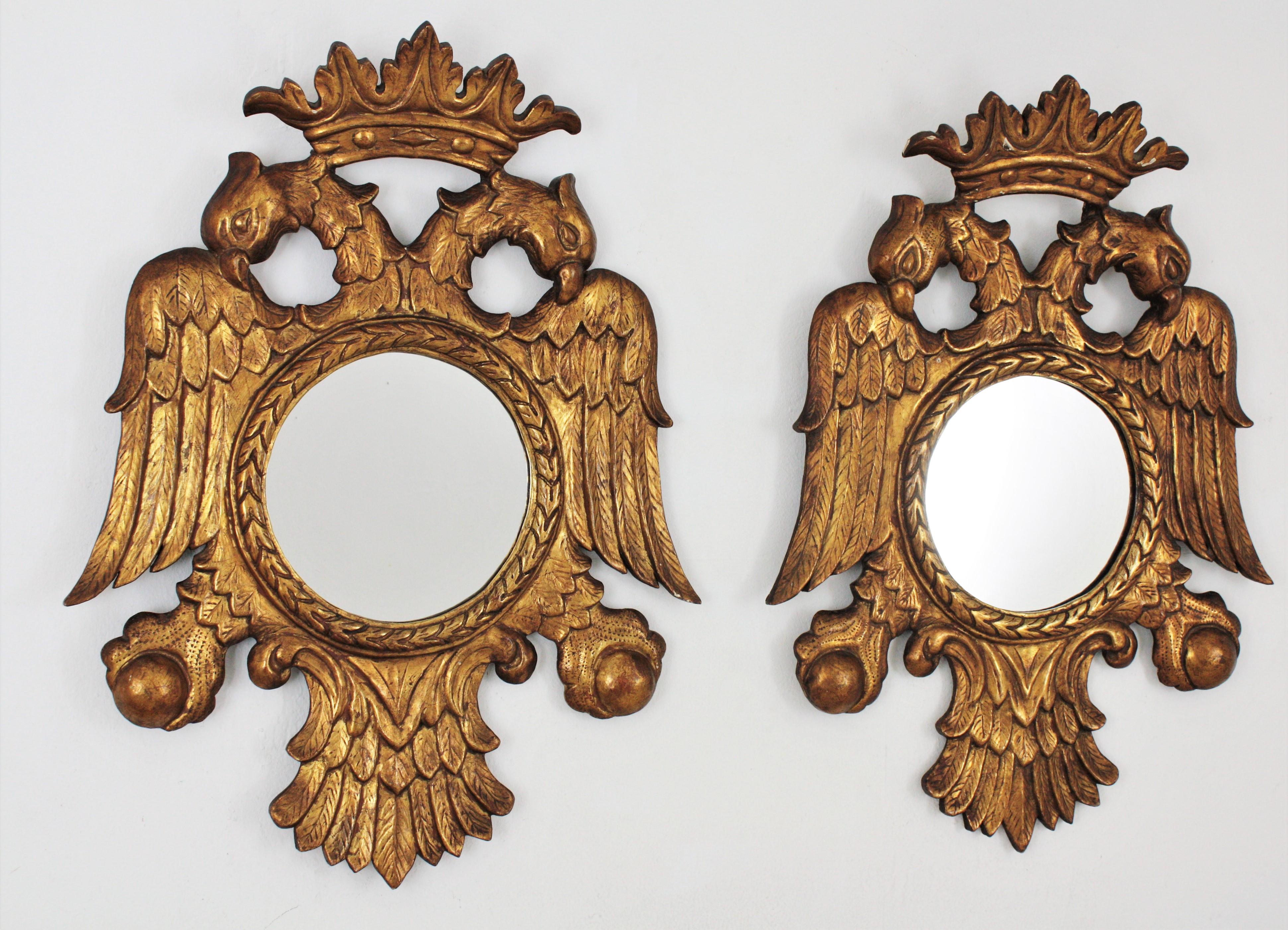 Pair of magnificent carved giltwood mirror frames in the form of a crowned bicephal eagle. Spain, 1890s
Highly decorative frames with double-headed eagles surmounted by a crown, symmetric wings and tails holding the central circular mirror and the