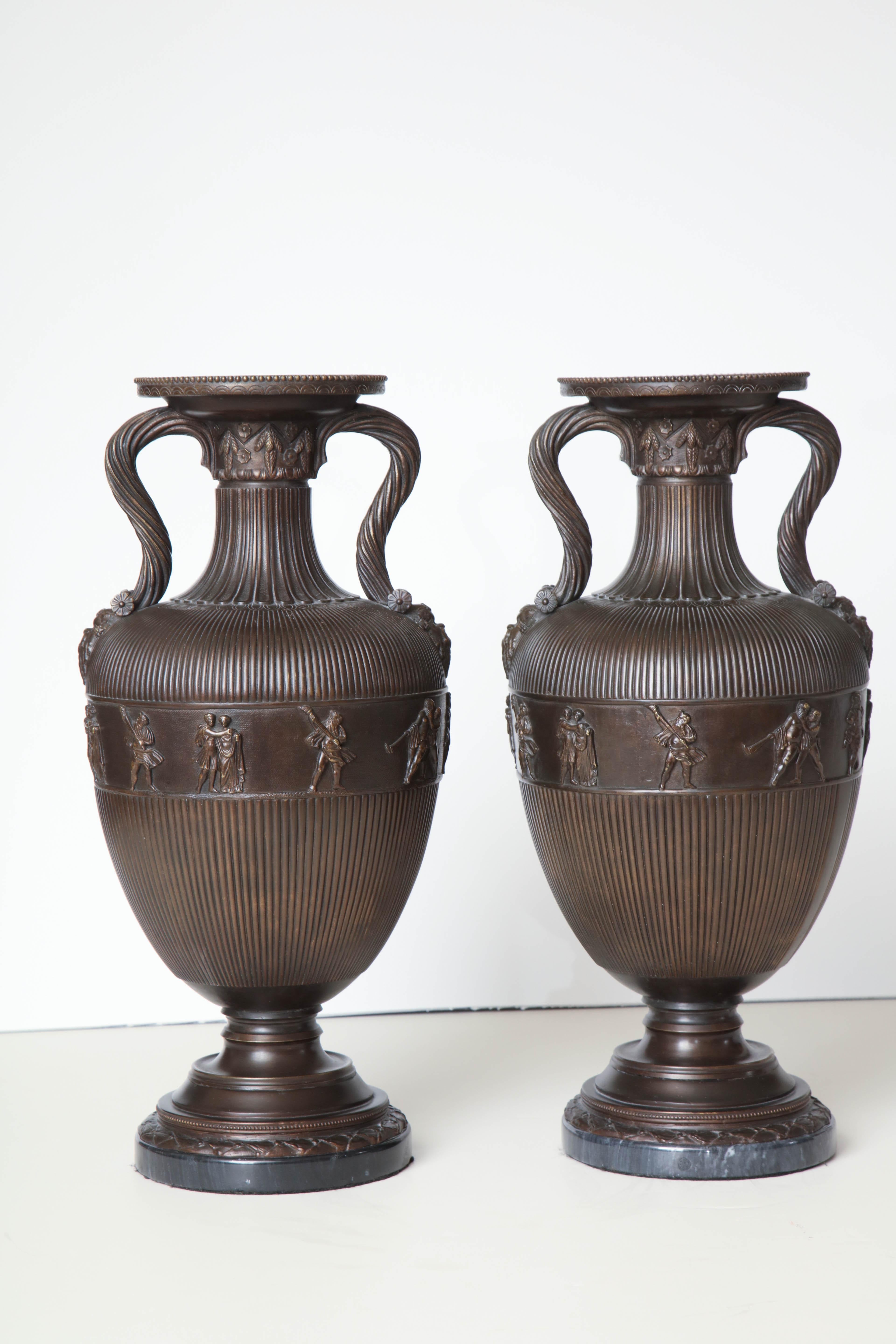 Superb pair of 19th century bronze urns, French, on marble bases.