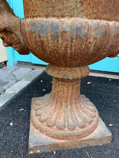 Pair of 19th Century Neoclassical Iron Urns with Handles and Face Detail