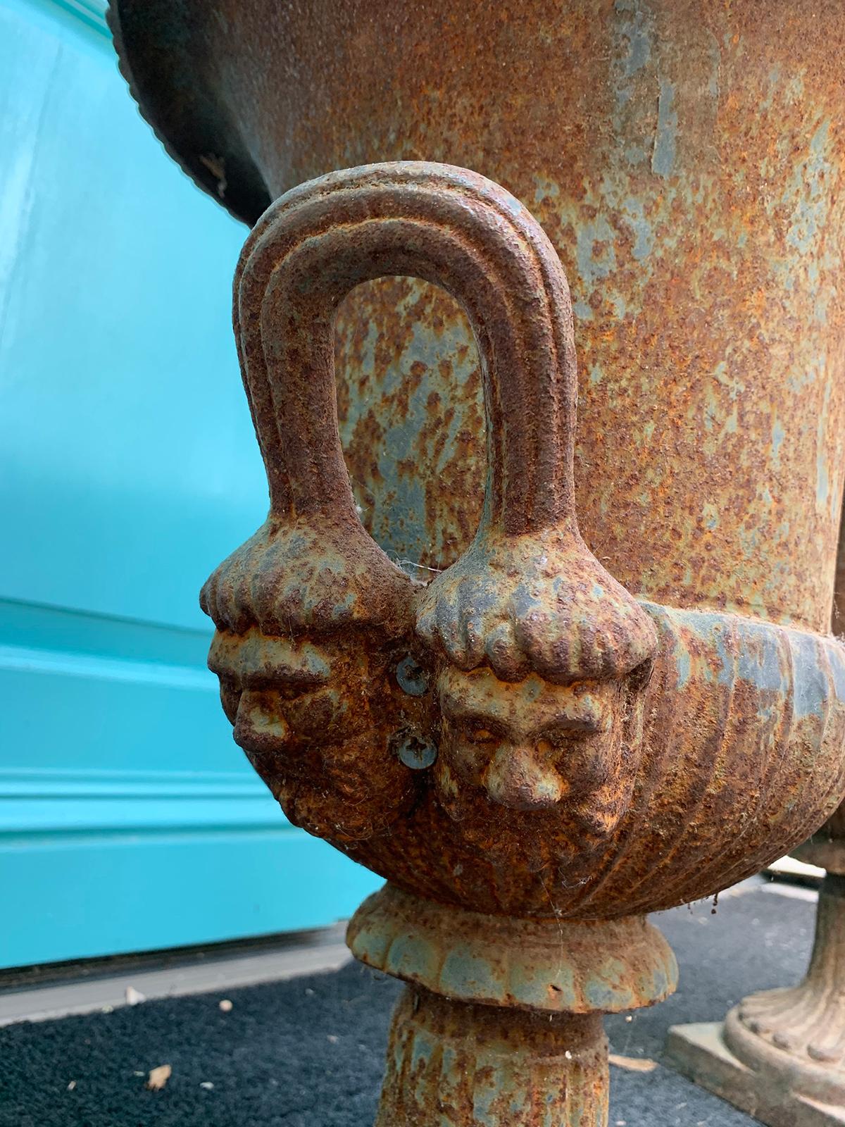 Pair of 19th Century Neoclassical Iron Urns with Handles and Face Detail In Good Condition For Sale In Atlanta, GA