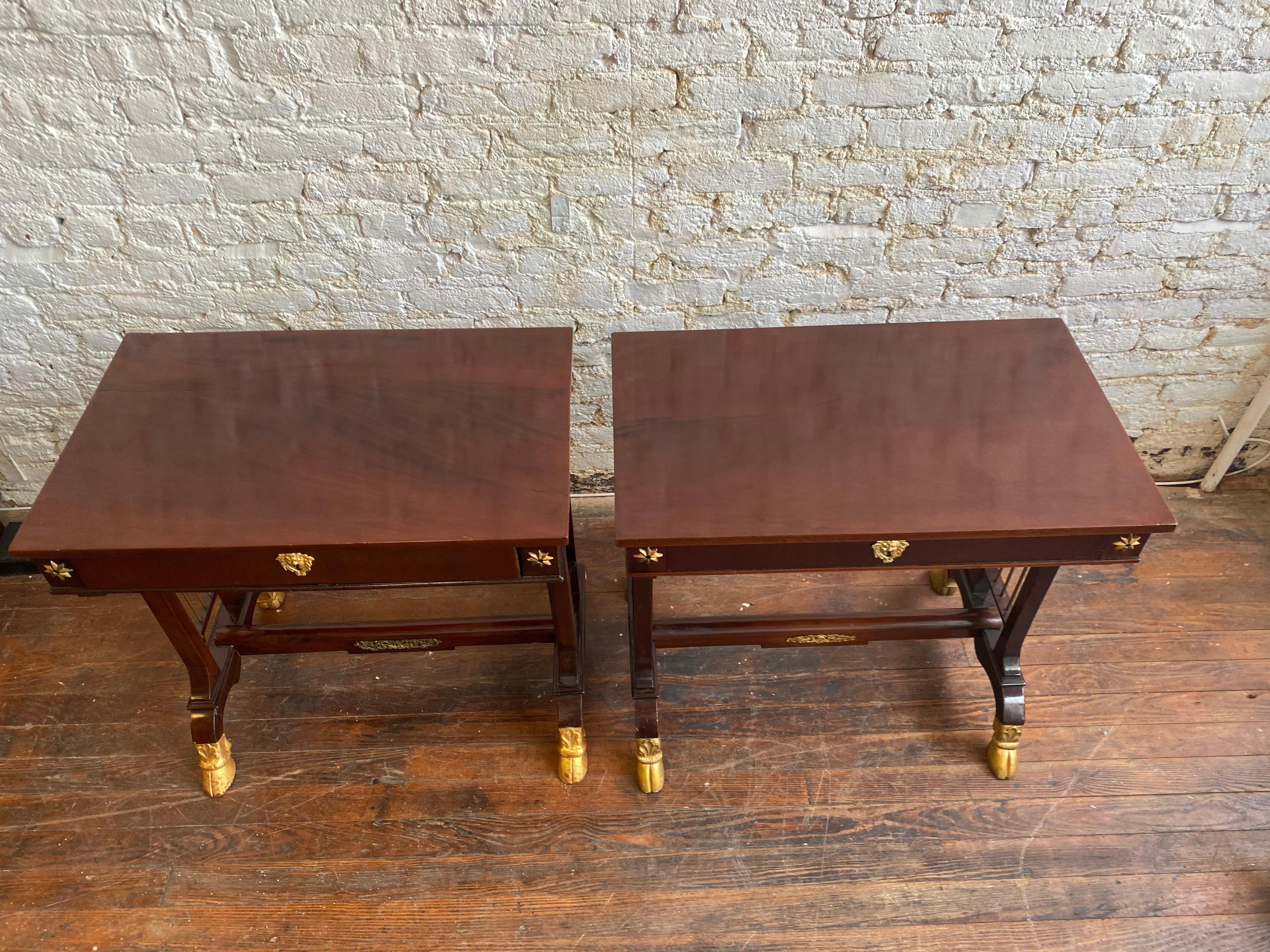 Pair of 19th century northern European neoclassical mahogany side tables with hoof feet. Possibly Russian. Parcel gilt on feet and bronze mounts.