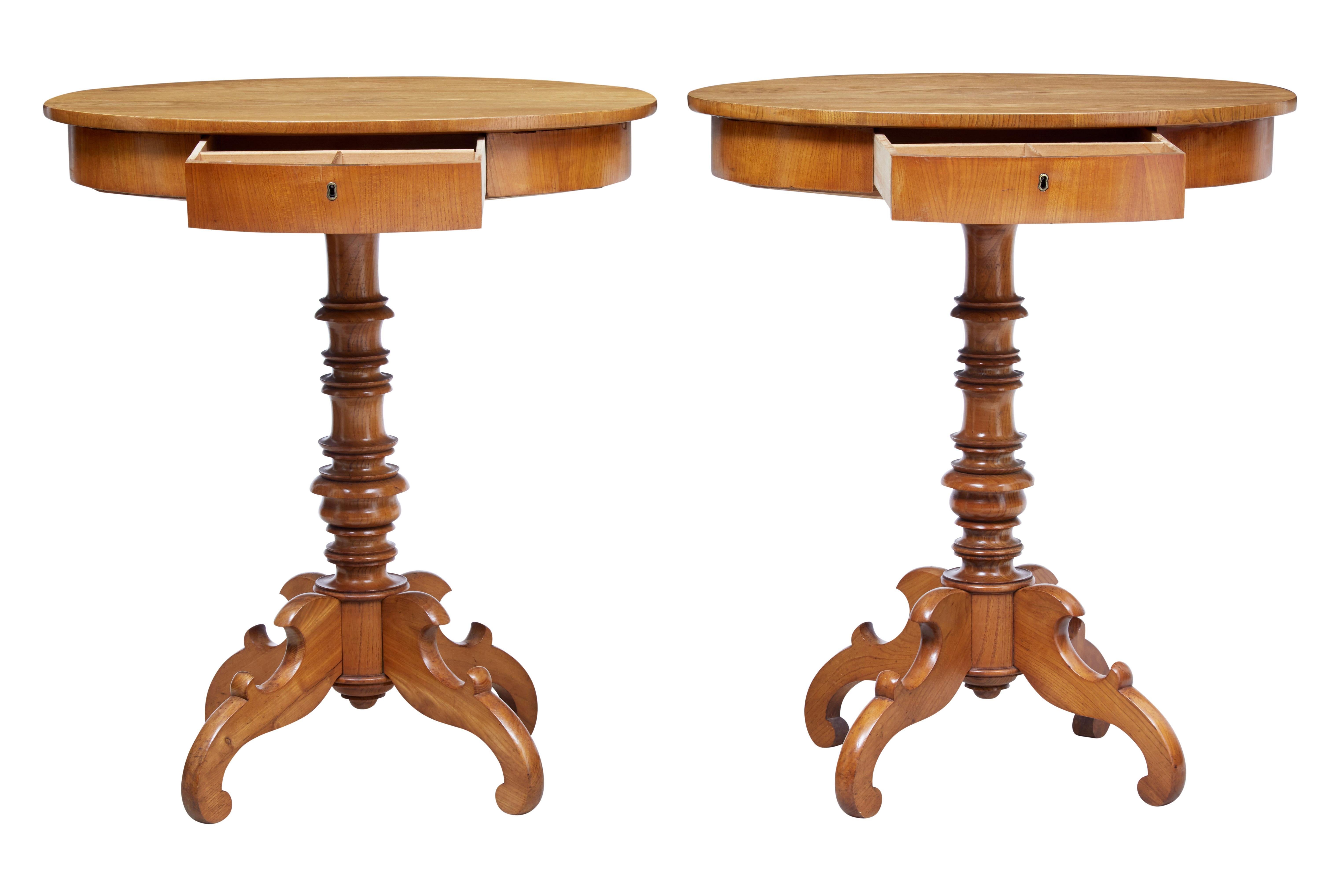 Good quality pair of elm occasional tables, circa 1890.

Oval tops with single drawer below which are fitted with partitions. Turned stem base, standing on 4 shaped legs.

Ideal for a pair of lamp tables.

Slight variation in color on the
