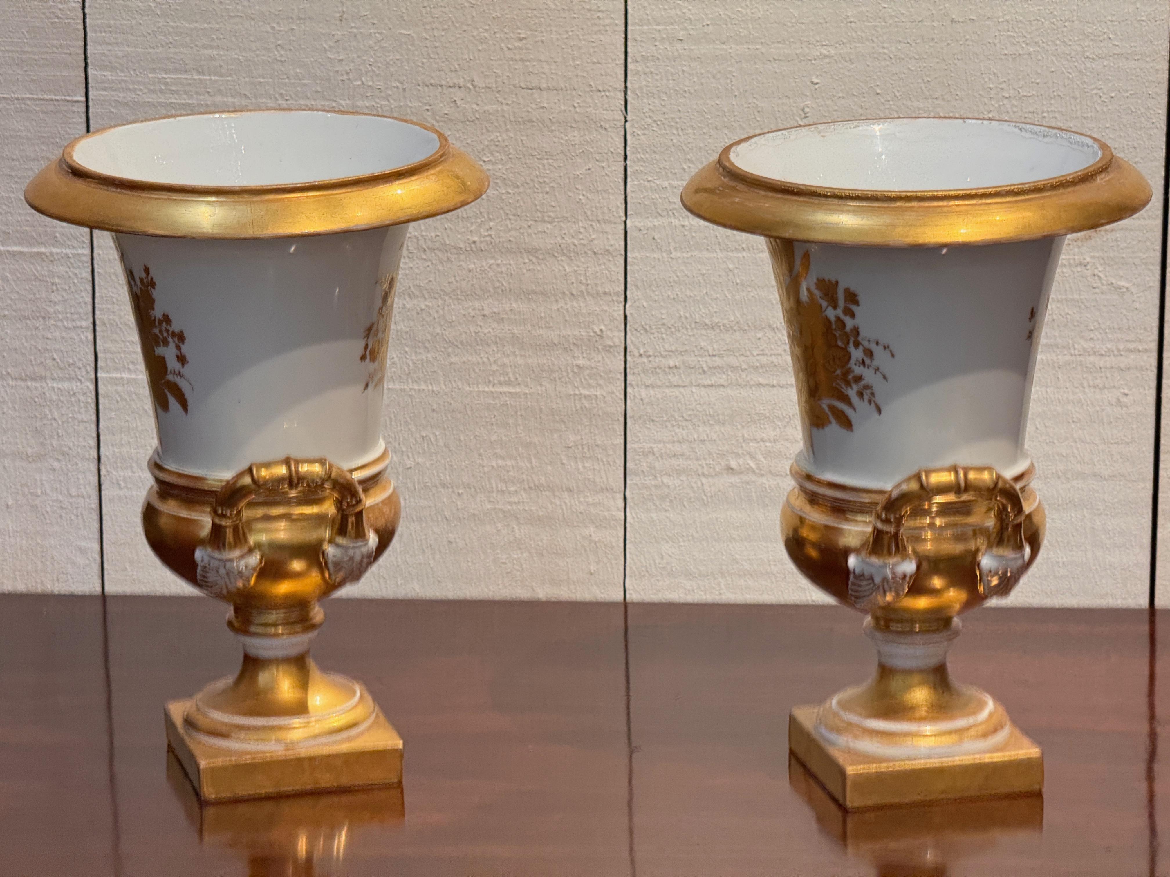 Porcelain Pair of 19th century Old Paris porcelain urns with gilt handles and footed squar For Sale