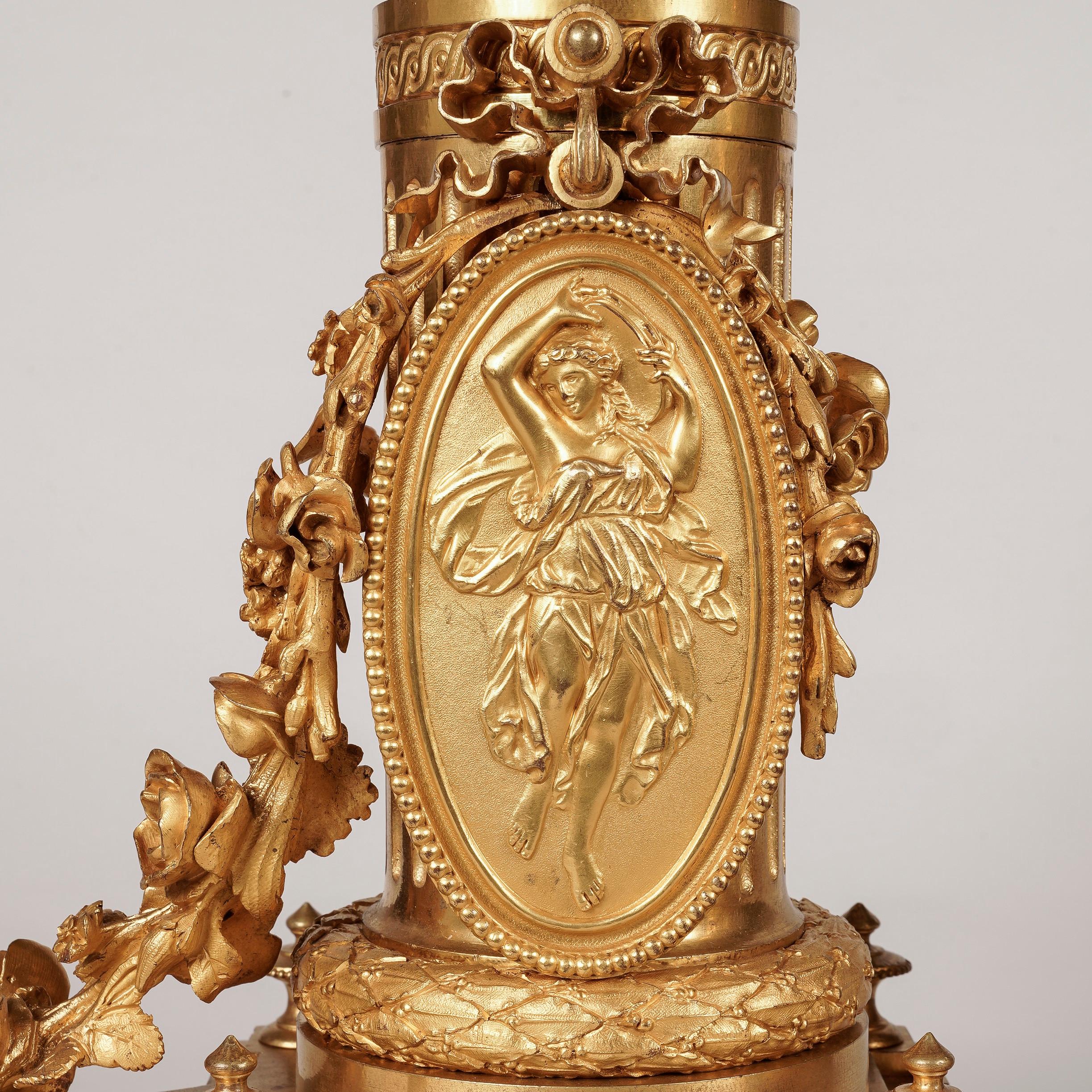 A pair of Louis XVI Style Chenets

Constructed from finely cast and chased gilt bronze, these decorative firedogs with attenuated rectangular plinths are supported on oblate toupie feet, the corners dressed with rosettes flanking pierced panels, a