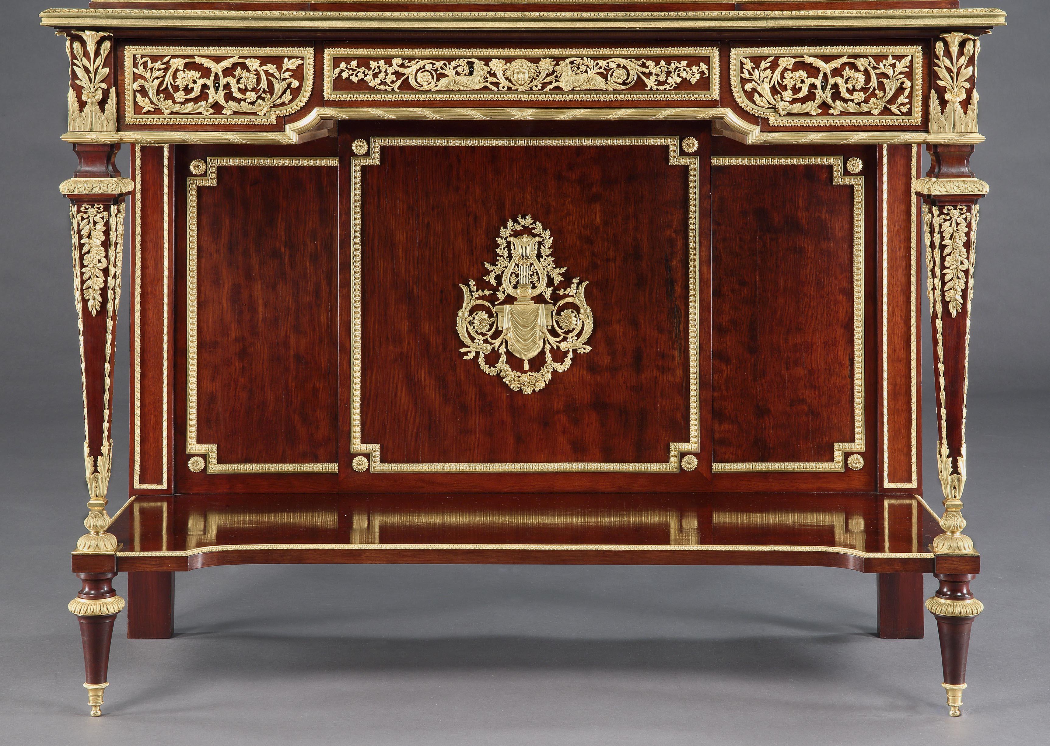 A remarkable pair of display cabinets
By Henri Picard of Paris

Constructed in mahogany, with extensive and superlative ormolu decoration. The cabinets of rectangular form, rising from turned and tapering toupie feet supporting an inverted