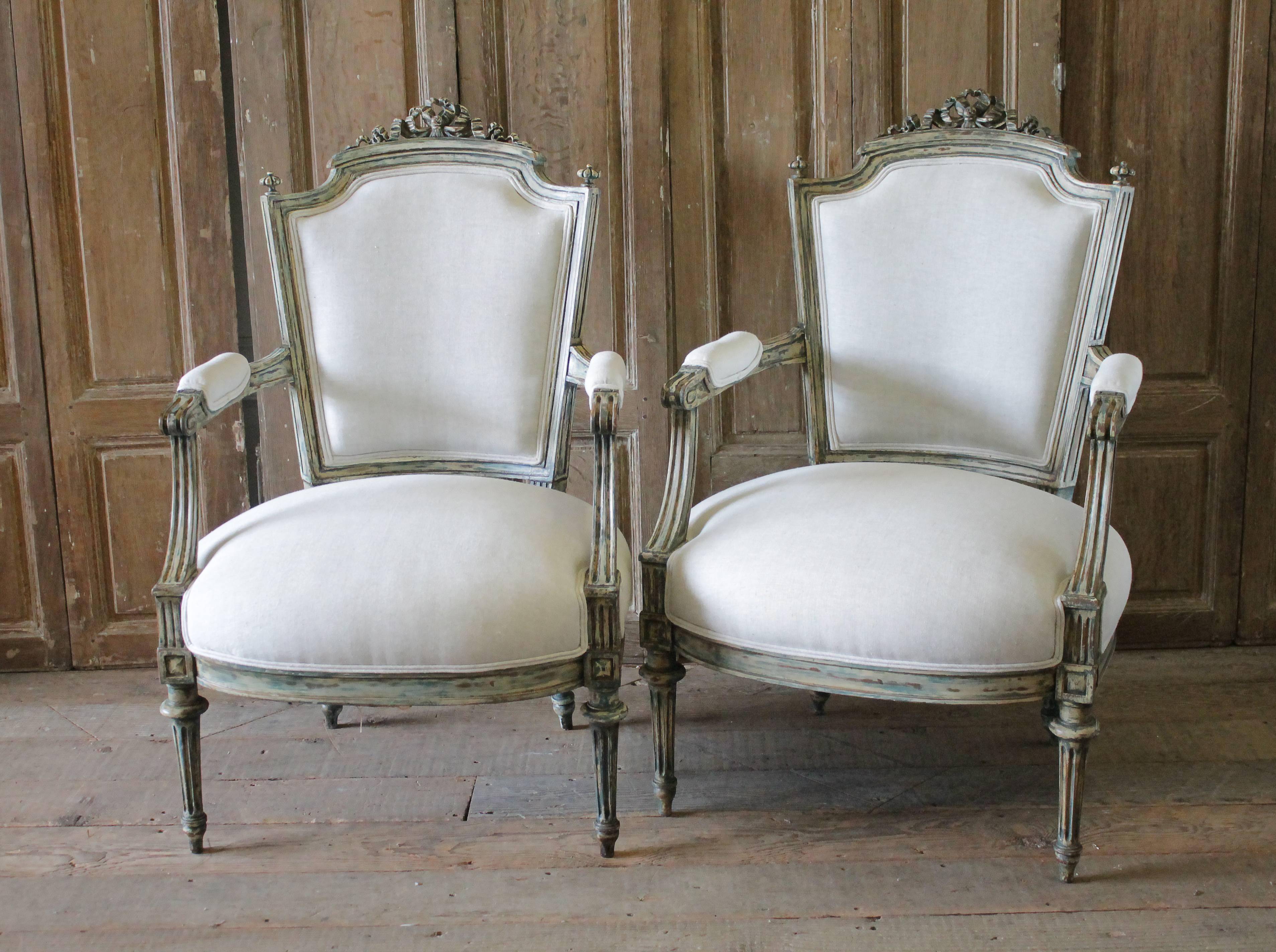 Pair of 19th century painted and upholstered Louis XVI style open armchairs
Beautiful armchairs with distressed weathered patina, paint is as found in a wonderful creamy white and French Aqua color exposing the wood tone underneath. The chairs have