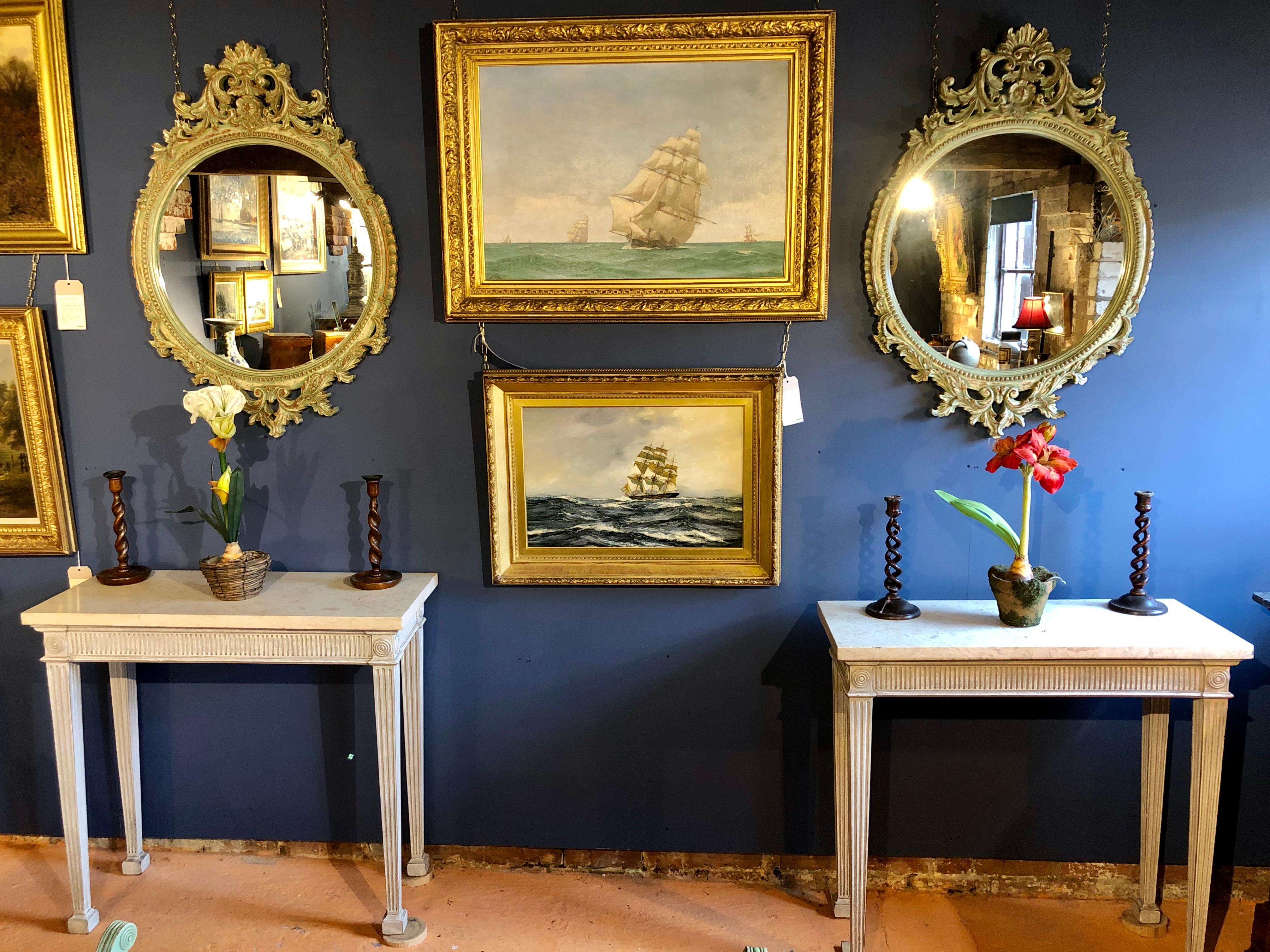 A pair of 19th century style well-proportioned wall mirrors with ornate decoration. The painted frames now beautifully distressed. Both in good condition.