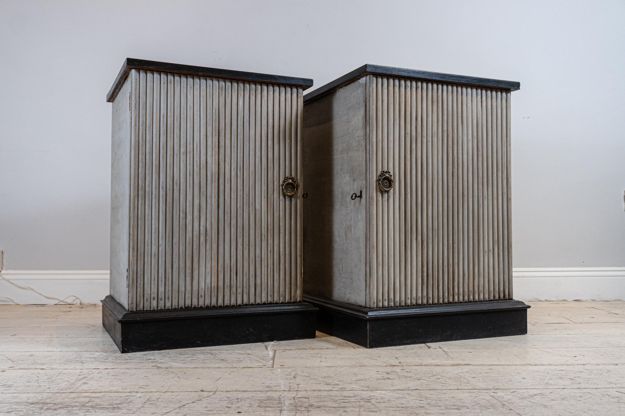 A wonderful and unusual pair of painted and ebonised side cabinets, cupboards or bedside tables.

The cabinets have been painted and adapted with reeded decoration to the front and sides with ebonised tops and stepped bases.

The interior of one