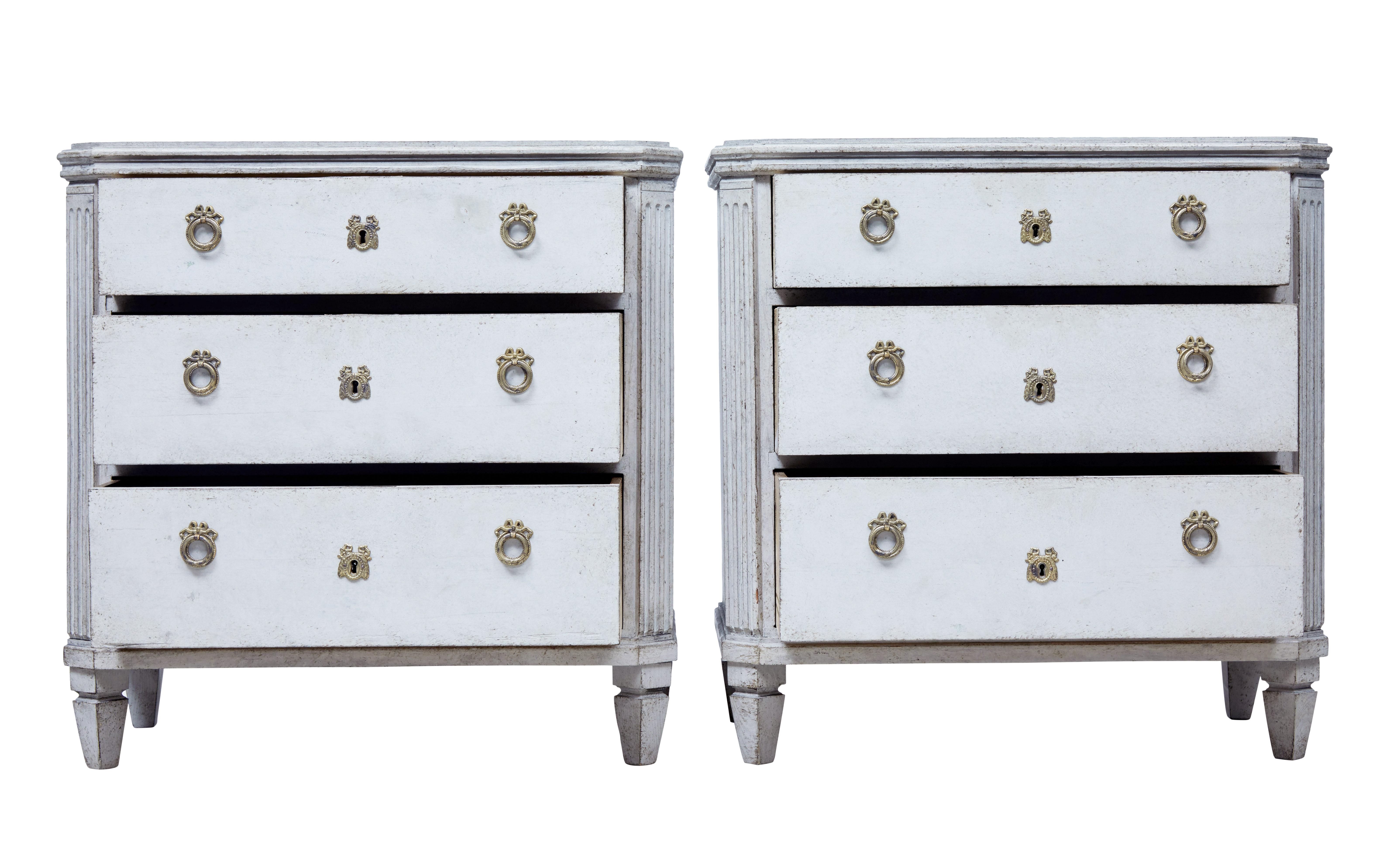 Fine quality pair of Swedish commodes in the Gustavian taste, circa 1870.

Stepped top and 3-drawers with working locks and fitted with later handles. Canted corners with fluted detailing. Standing on tapered legs.

Later paint which has taken