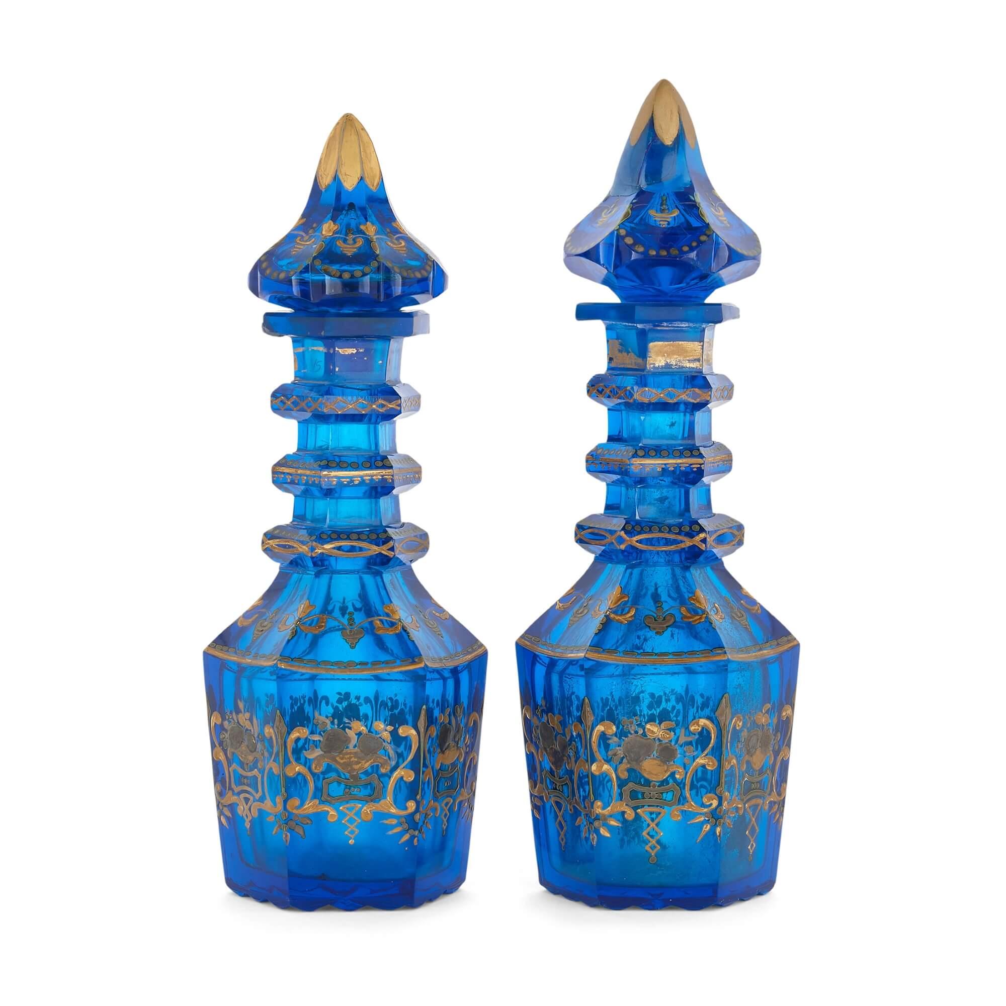 Pair of 19th Century parcel gilt Bohemian glass decanters
Bohemian, 19th Century
Height 27cm, diameter 8.5cm

This fine pair of decanters are crafted in royal blue Bohemian glass, and feature hexagonal baluster form bodies which lead upwards to