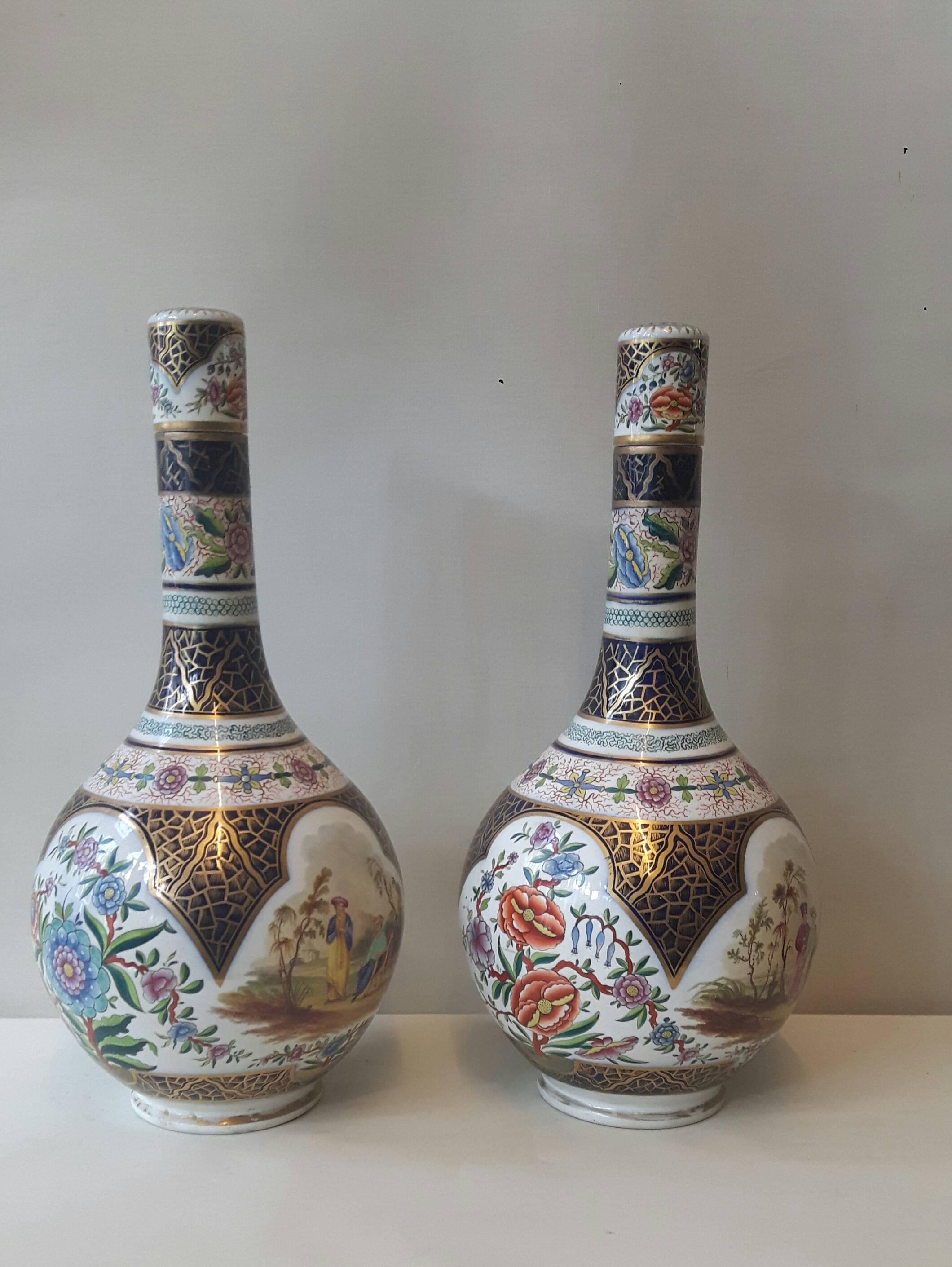 A lovely pair of bulbous-shaped Continental porcelain vases and covers. the central parts hand-decorated with cartouches of Eastern-style courting and flower scenes, the necks sporting bands of flower garlands, all on a heavily painted blue and