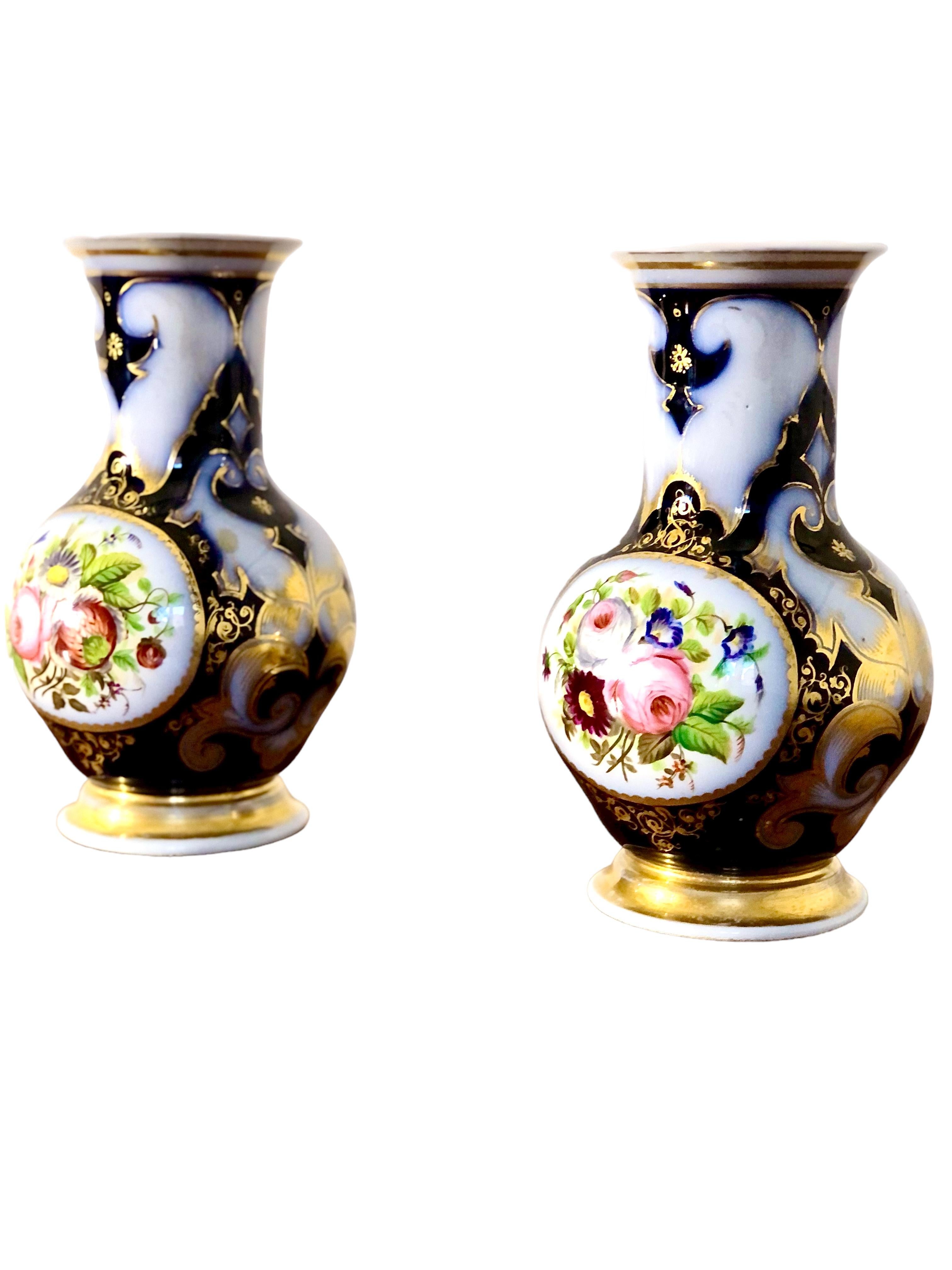 These exquisite Parisian porcelain vases boast a timeless elegance that is sure to impress any art lover. Their classic design features a stunning navy blue backdrop that perfectly sets off the beautifully painted roses that adorn them. The