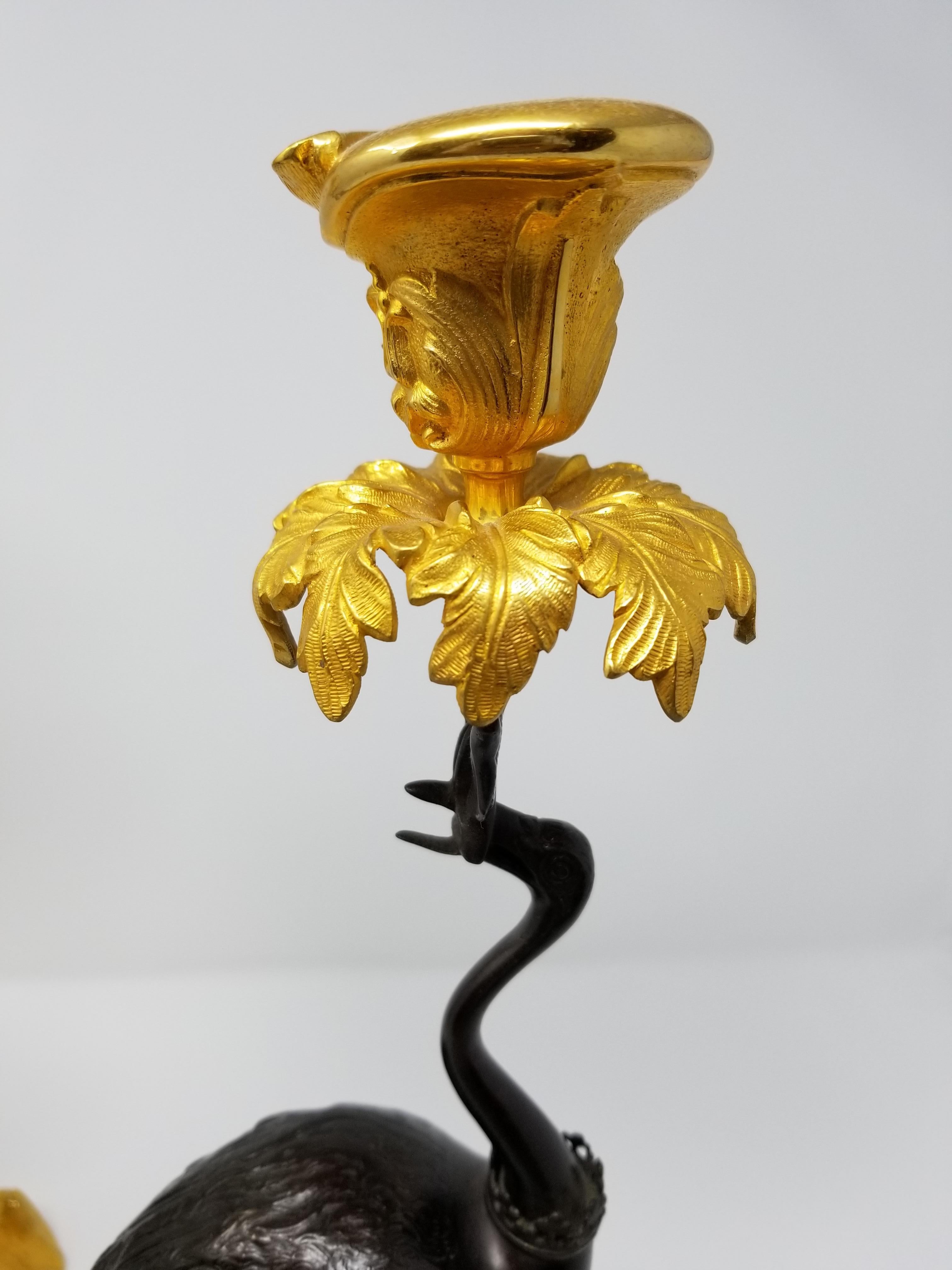 Chinoiserie Pair of 19th Century Patinated and Gilt Bronze Standing Crane-Form Candlesticks