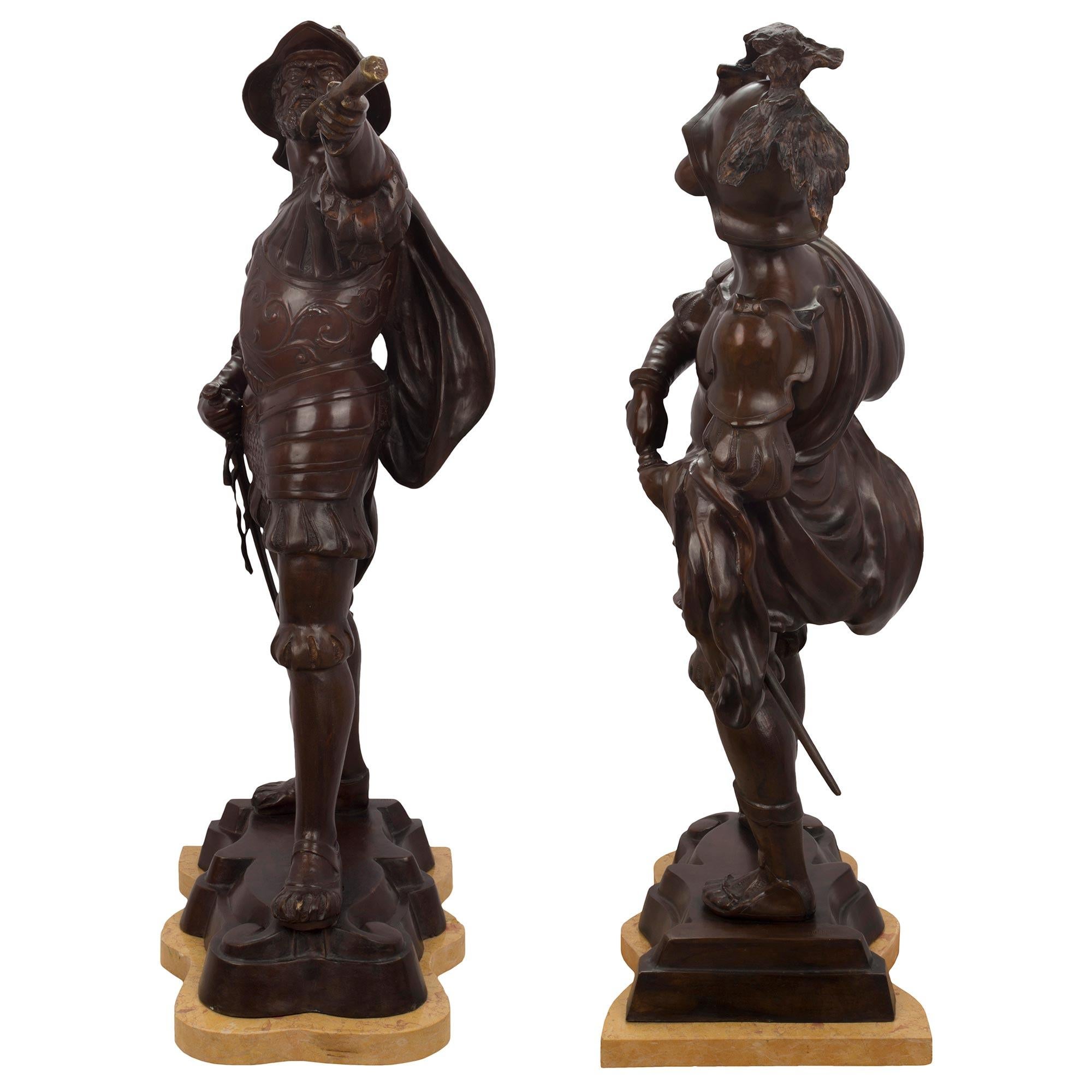 An impressive and true pair of late 19th century patinated bronze and sienna marble warrior statues. Each statue is raised on a curved sienna marble support below the patinated bronze base signed Hunt. One figure has an elaborately chased armor with