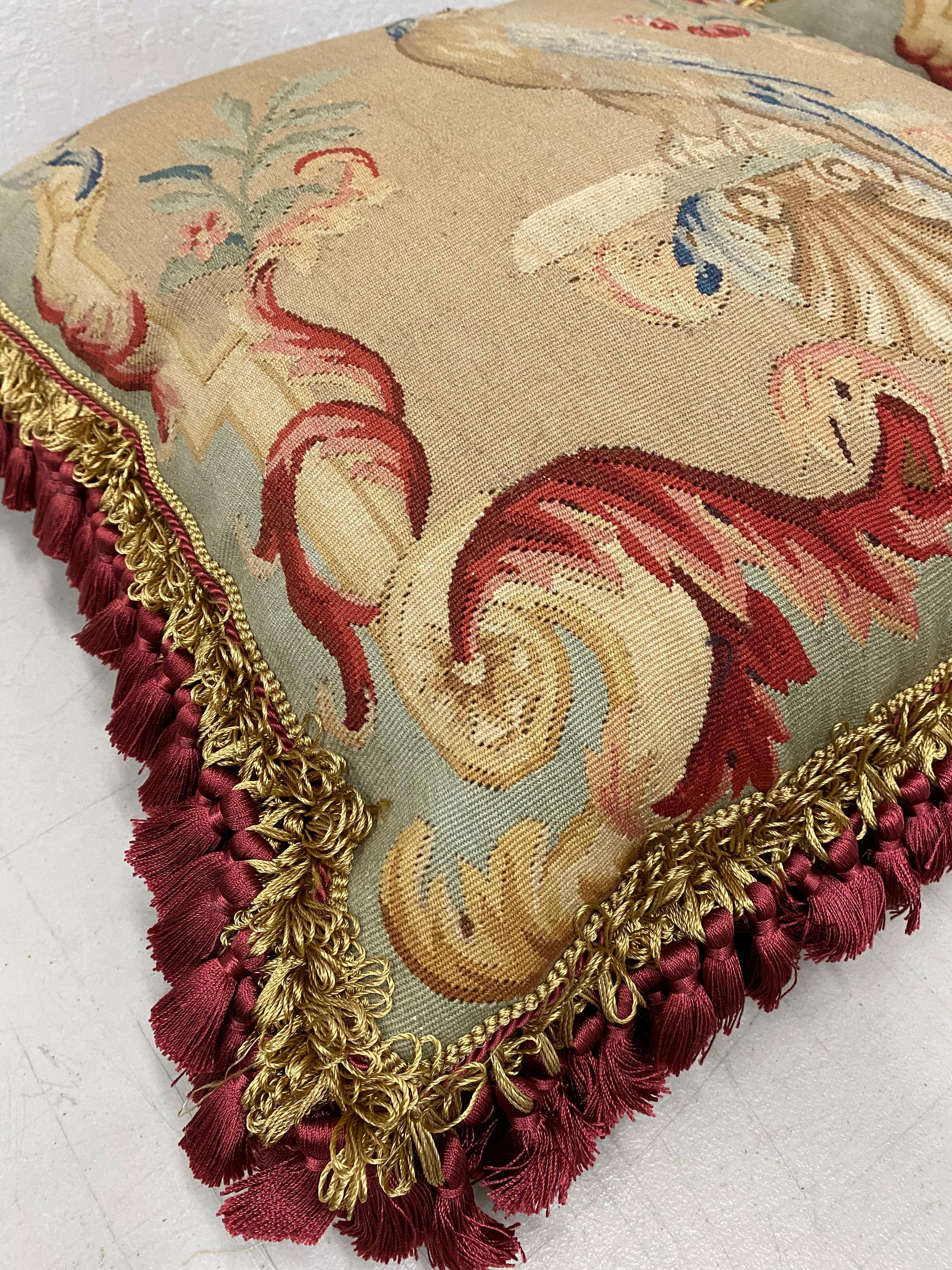 Pair of 19th century Petit point over mid-20th century pillows 

Gorgeous marriage of antique petit point with matching birds over mid-20th century pillows with tassels and plush filling.

Each pillow measures 22