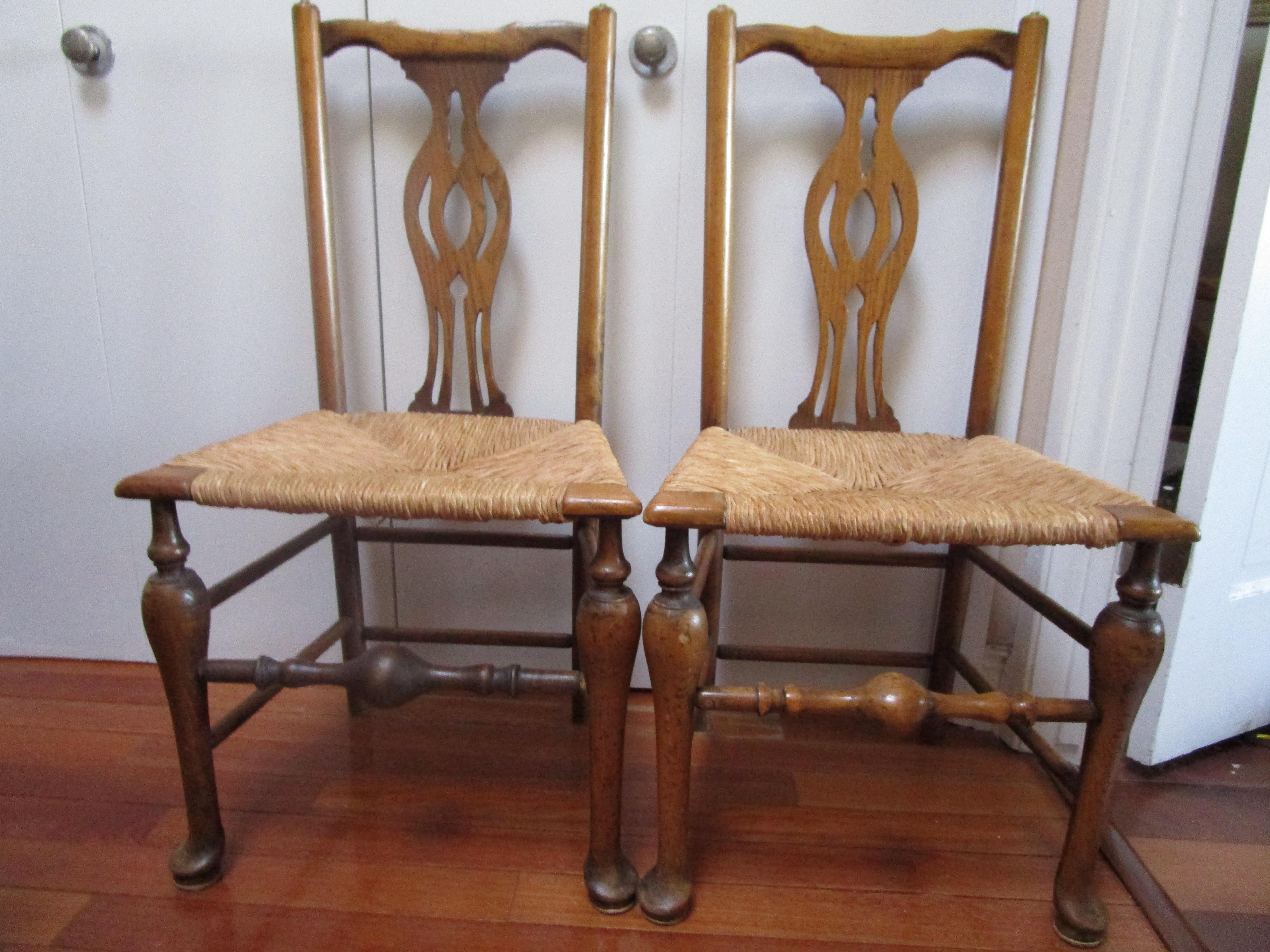 This pair of 19th Century Queen Anne side chairs with rush seats are in fine condition. This pair presents so beautifully with the maple wood, which has developed a fine patina over the years. The pair of chairs feature oak and maple. They are
