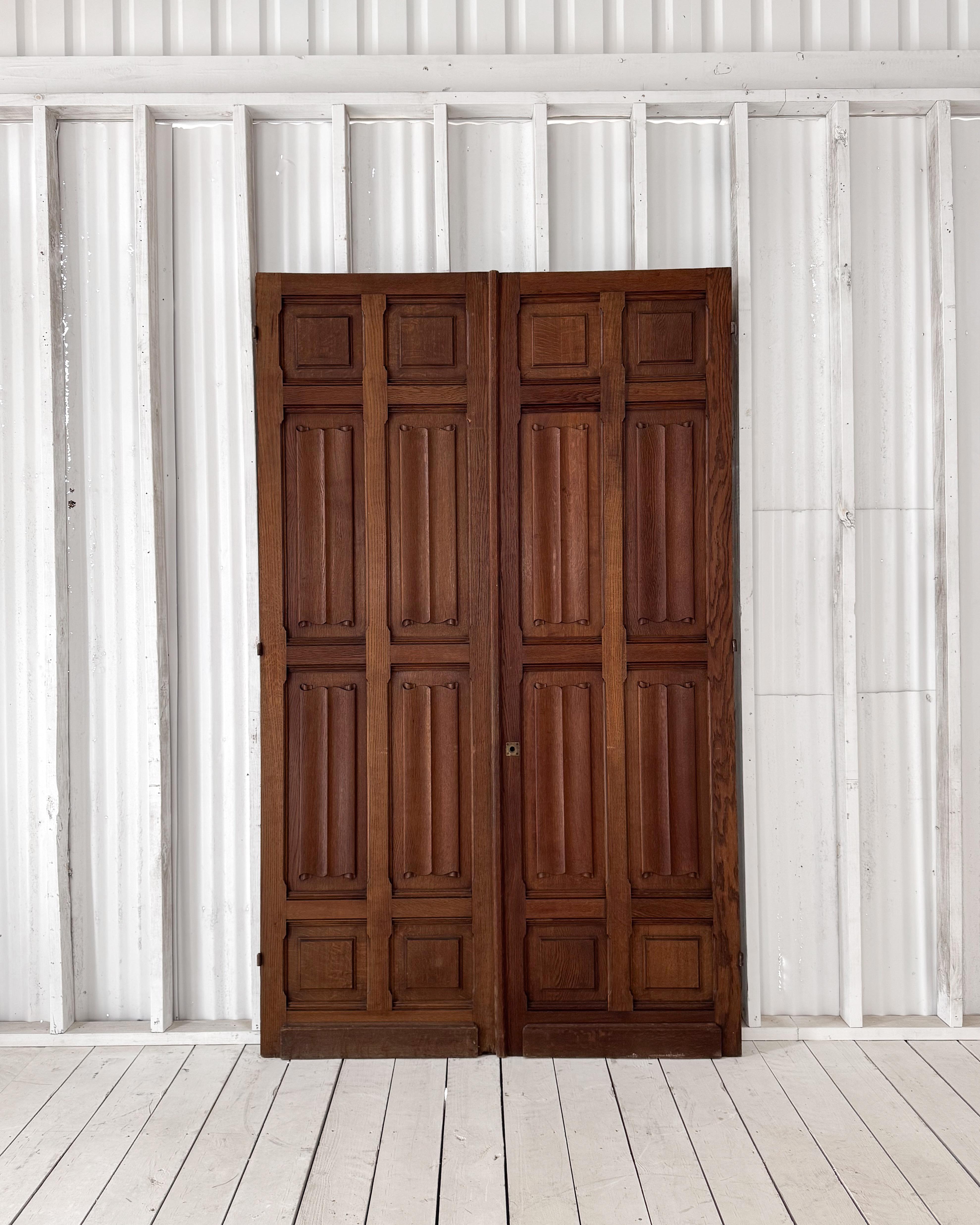 Striking double-sided French doors, crafted from solid oak in the 19th century and reclaimed from a historic property in France. Each panel showcases a different character-rich finish: one side features a rich warm stain that accentuates the