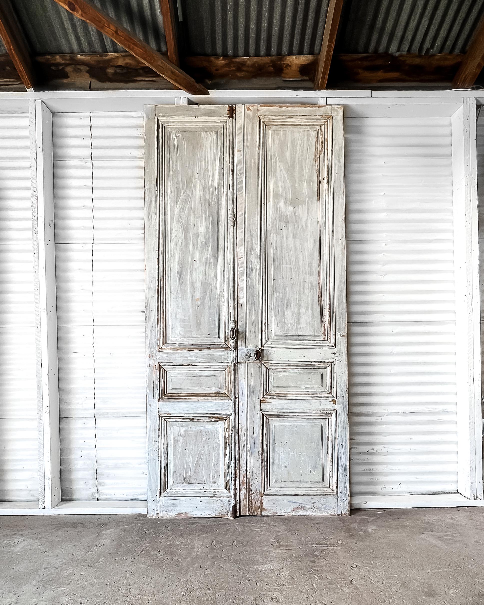 Reclaimed solid oak raised panel interior doors with a worn appearance to the original pale blue paint. Once gracing a beautiful French home, these doors will add character and old-world charm to your modern home.

Salvaged in France, circa