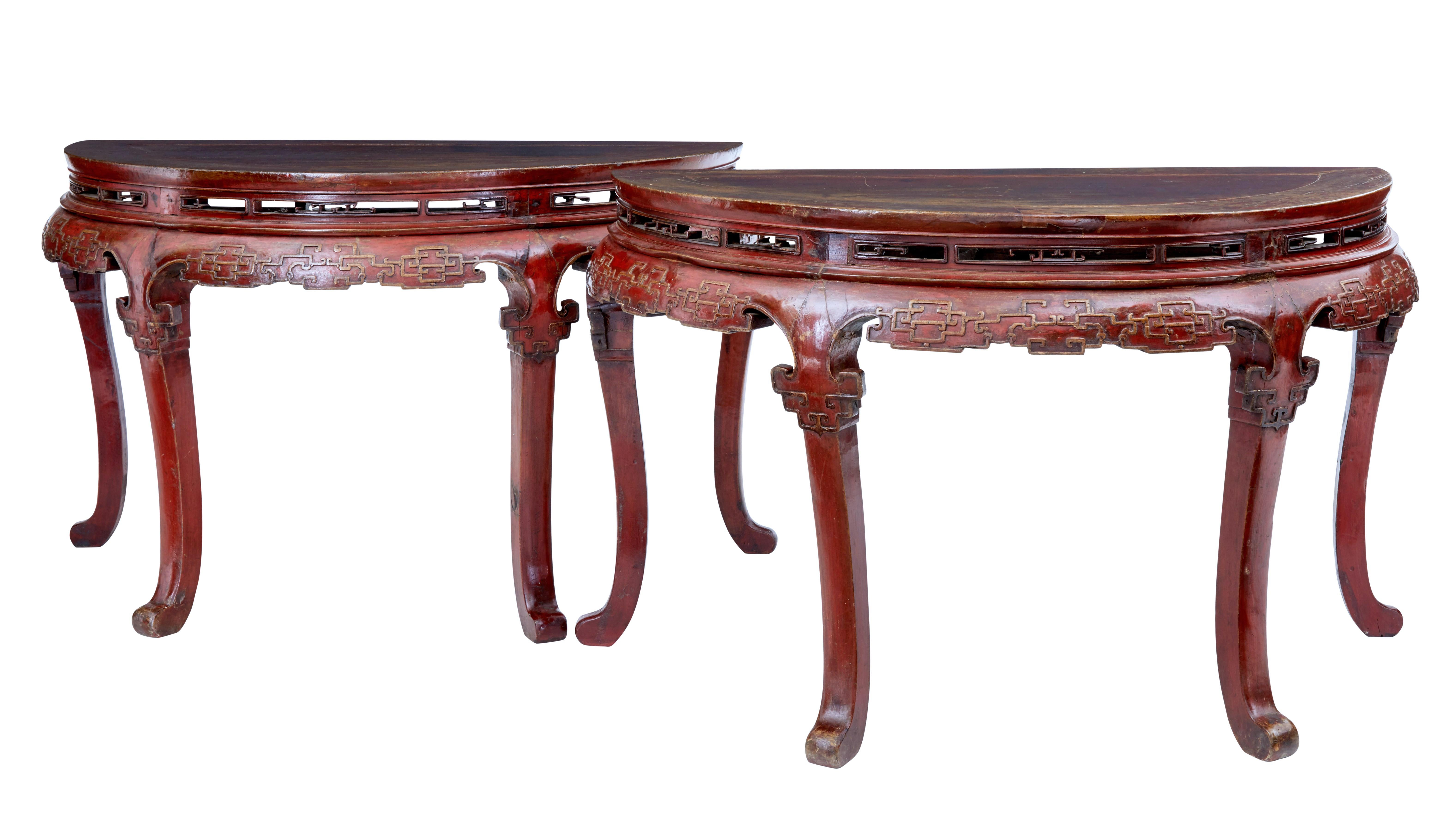 Pair of 19th century red lacquer Chinese demilune tables, circa 1880.

These tables work as a pair of demilune tables and stand back to back, slotting together to form a center table or even a dining table.

Pierced apertures below the tabletop,
