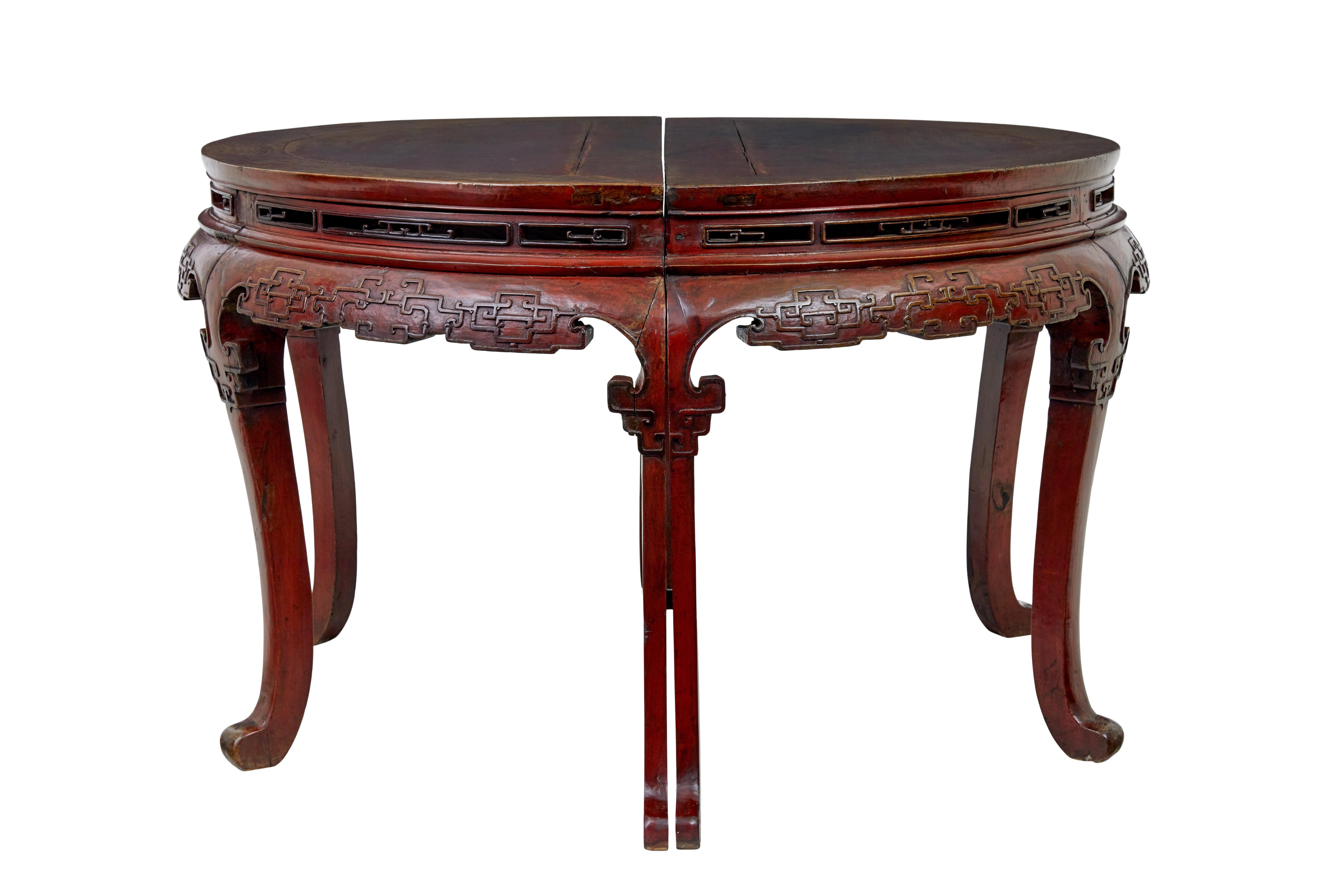 Pair of 19th century red lacquer Chinese demi lune tables circa 1880.

These tables work as a pair of demi lune tables and stand back to back, slotting together to form a center table or even a dining table.

Pierced apertures below the table top,