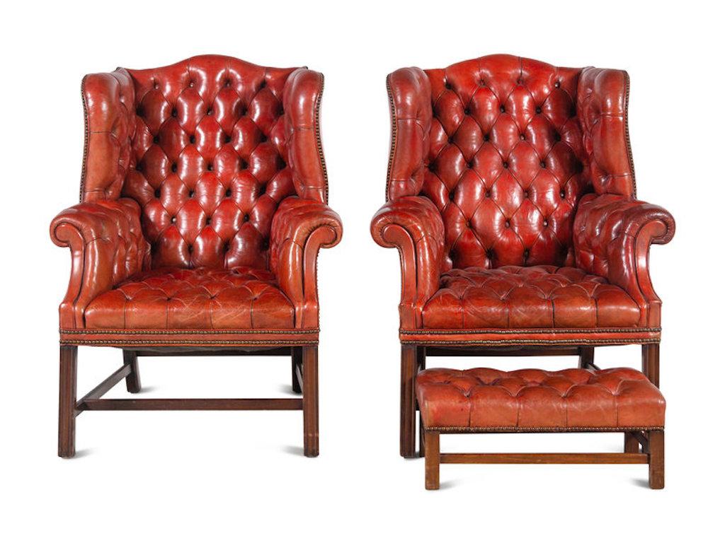 Pair of Red Leather Covered Chippendale style wing armchairs. Marlborough legs. Tufted. Leather in good condition with minor marks and a few buttons needing attention. But overall usable.

Comes with one ottoman.