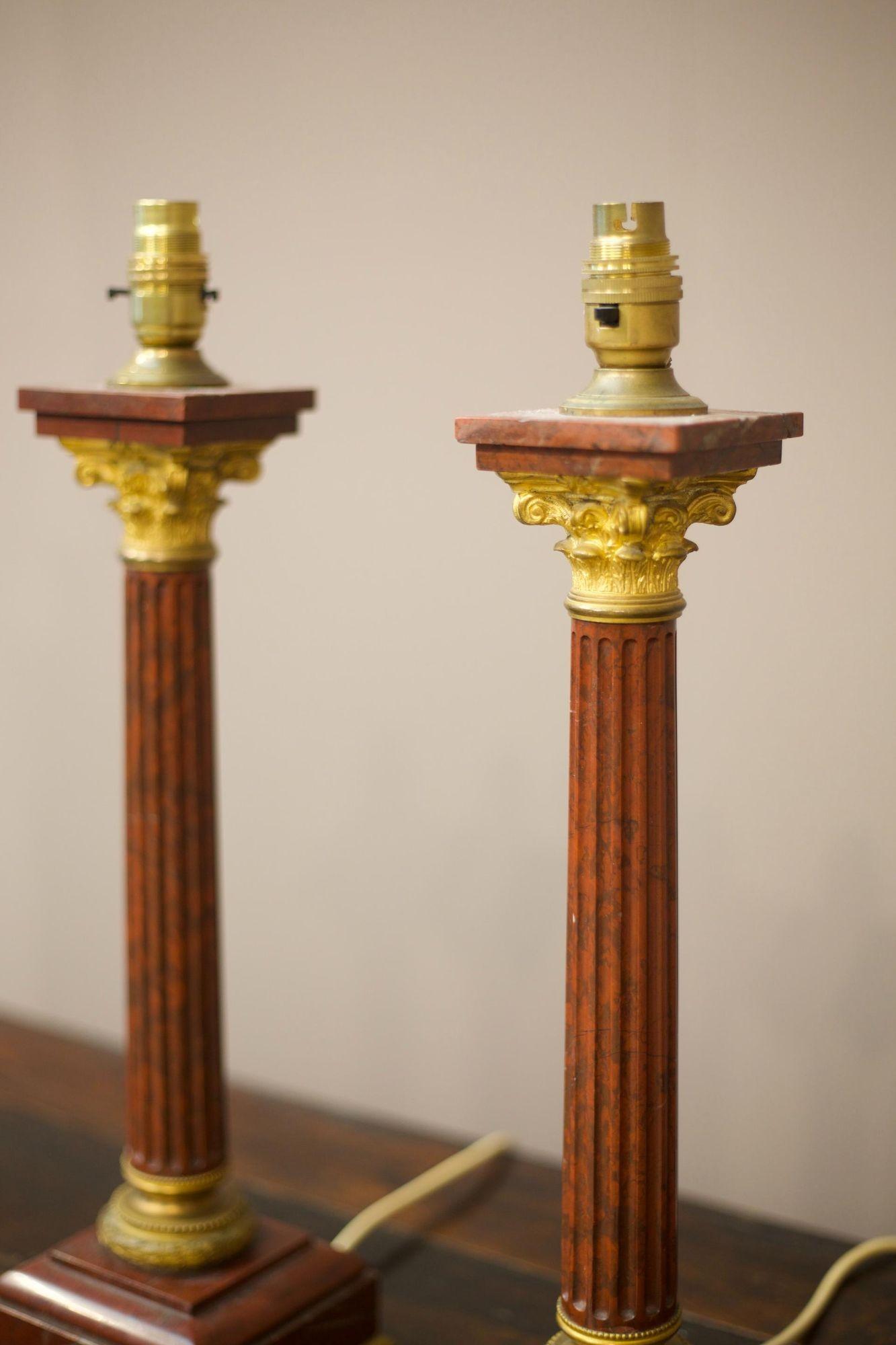 These are a very fine pair of Red marble and Ormolu table lamps. In the ground tour taste with Corinthian column design. Hard to date exactly but I would be confident in saying early to mid 19th century. These will be re wired before delivery.