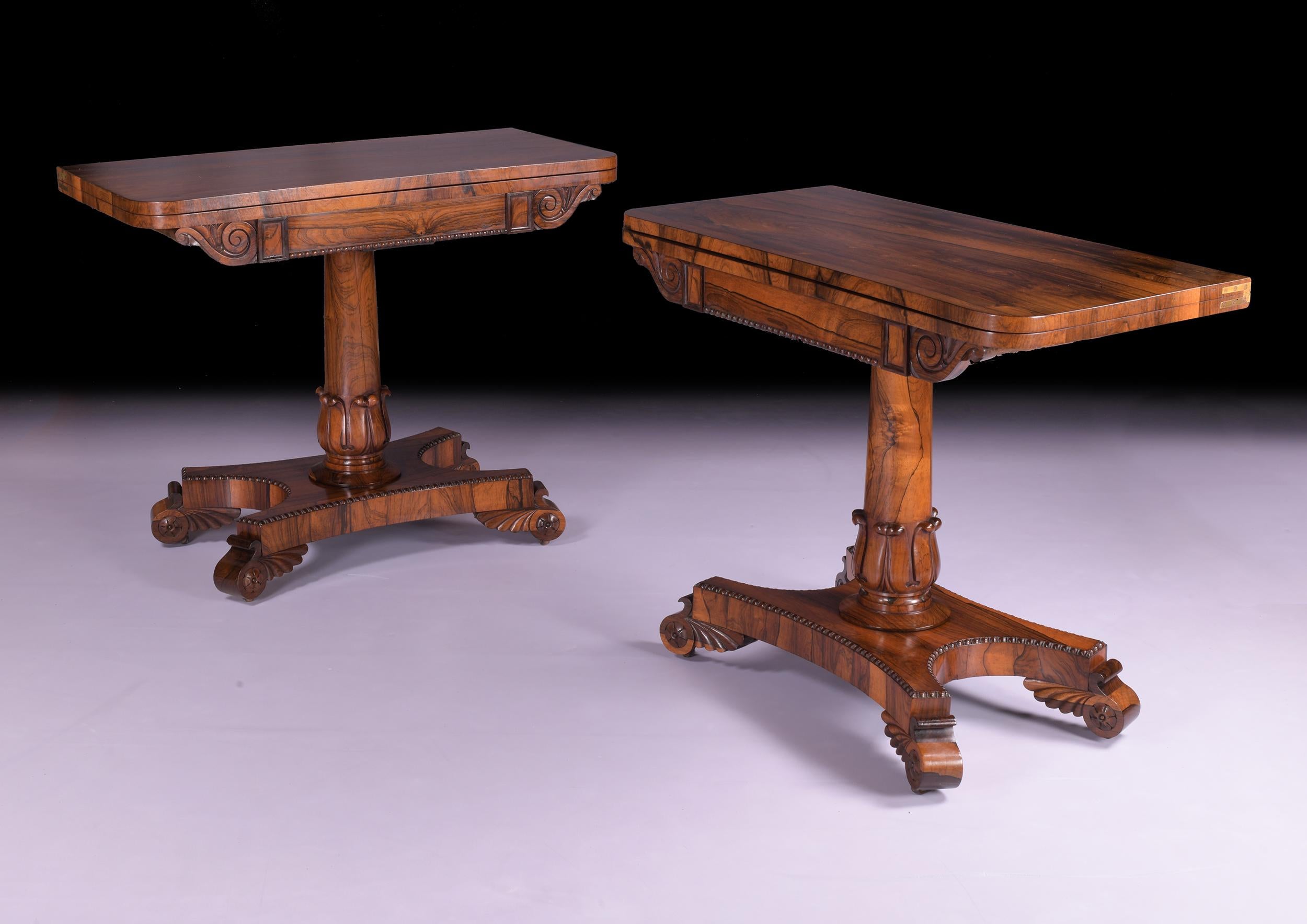 A stunning pair of Regency turnover card / games tables with rounded front corners enclosing a green baize lined interior. Each frieze with a rectangular gadrooned panel on a cylindrical shaft resting on a platform base and carved scroll feet with