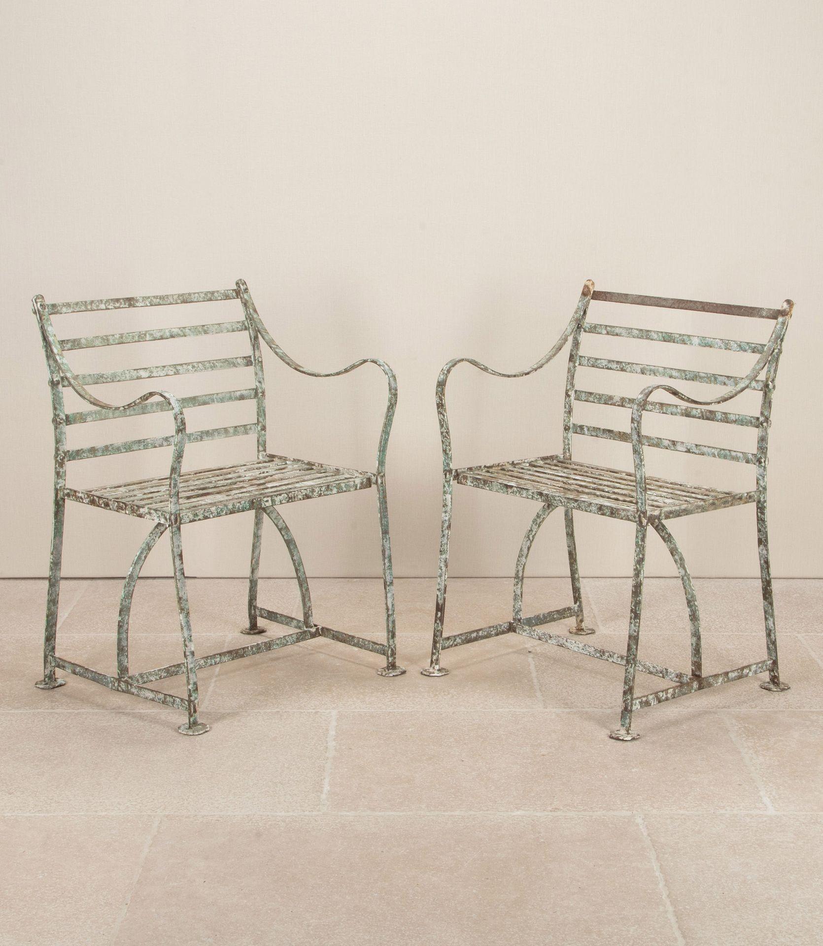 Pair of 19th Century English Regency wrought iron strap work garden seats.
These Regency seats stand on octagonal feet as to prevent sinking into the ground.
They have a gentle sloping back with scroll down arms. There is evidence of old paint