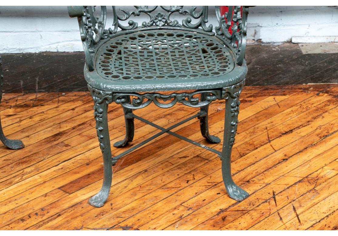 Robert Wood cast iron garden chairs, Philadelphia, mid-19th century. In two sizes. The front seat rail on the gentleman's chair is marked 'Robert Wood Maker Ridge Rd. Phila. 
In dark green paint. With Classic 19th century scrolled design