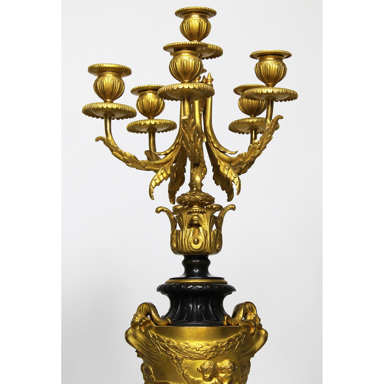 A fine pair of French 19th century Rococo Revival style gilt bronze and Rouge Griotte marble six-light candelabra attributed to Ferdinand Barbedienne (French, 1810-1892) After a model by Claude Michel (French, 1738-1814) known as Clodion. The