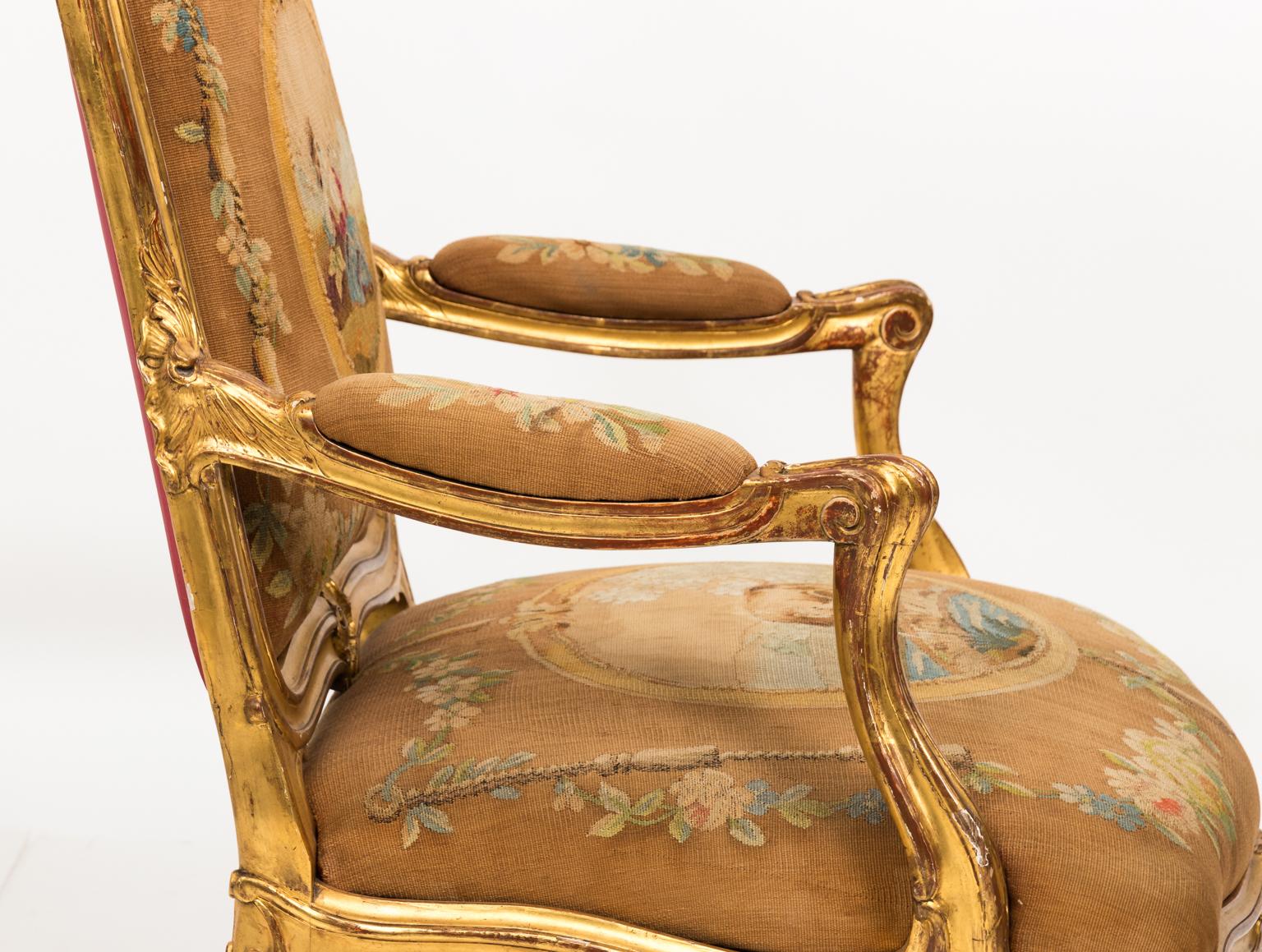 Pair of 19th century French Rococo gilded bergères chairs with Aubusson fabric. Some scratched, nicks to finish, stains to original fabric.
 