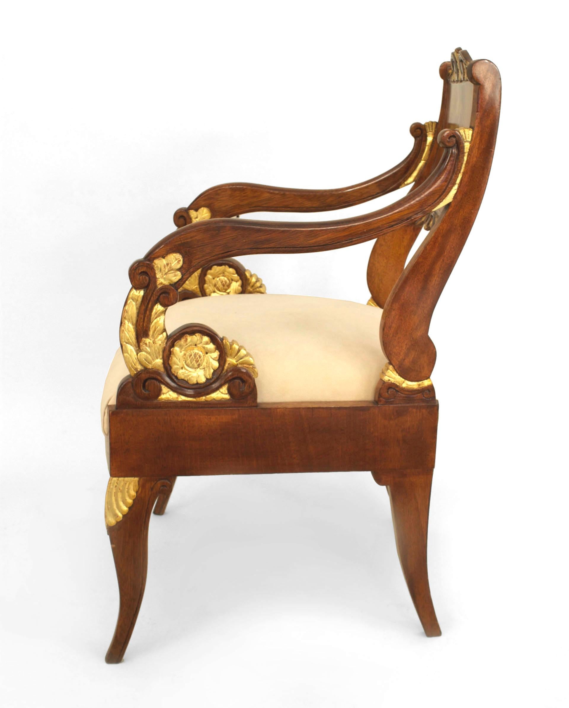Pair of Russian (19th Cent) mahogany open scroll design Armchairs with gilt carved trim on back and arms and an upholstered seat

