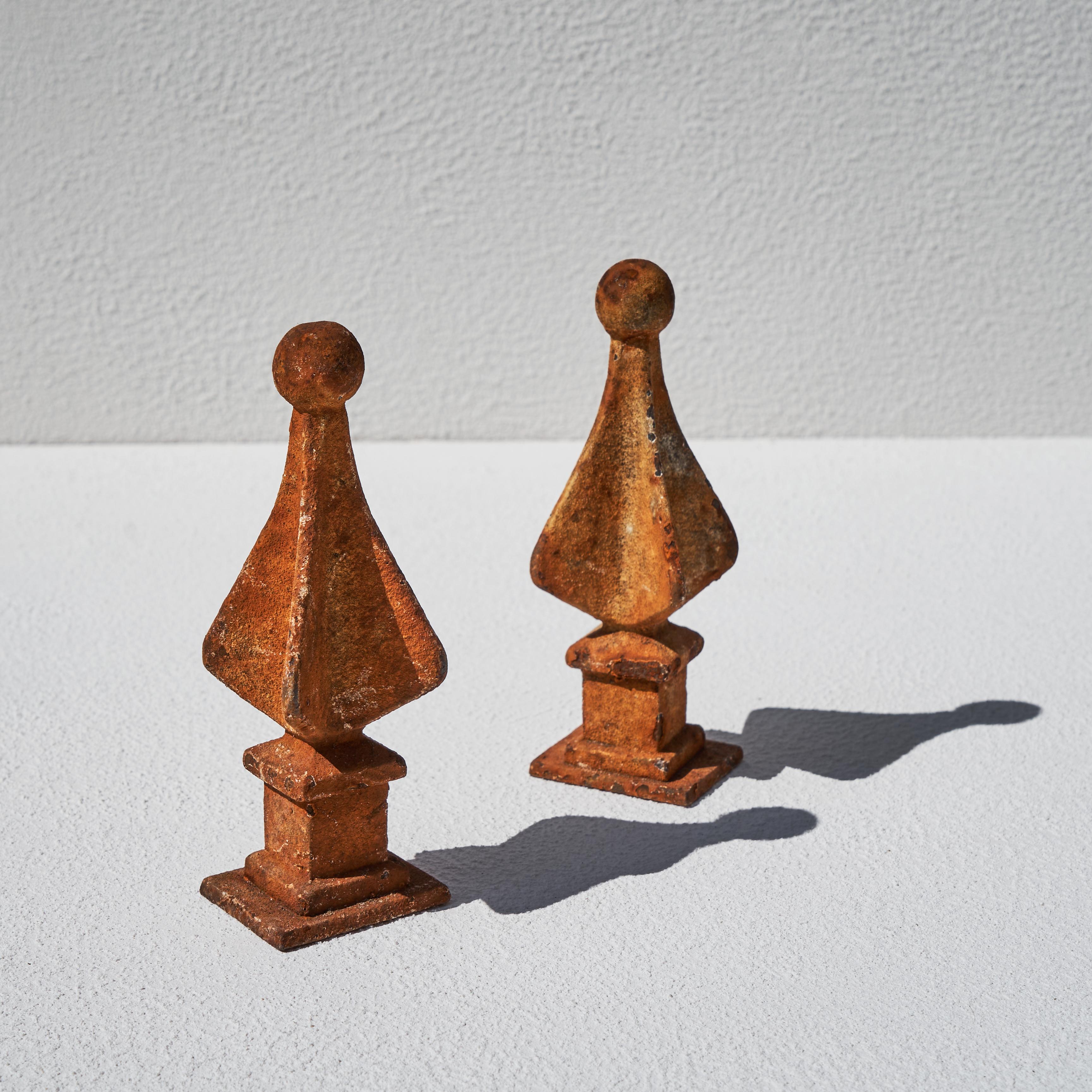 Pair of Rusted Decorative Finials. End of 19th century. 

This is a wonderful antique pair of rusted (fence) finials. Great as decoration on a desk, cabinet or table or usable as bookends.

Elegant and well proportioned quadrilateral shape with