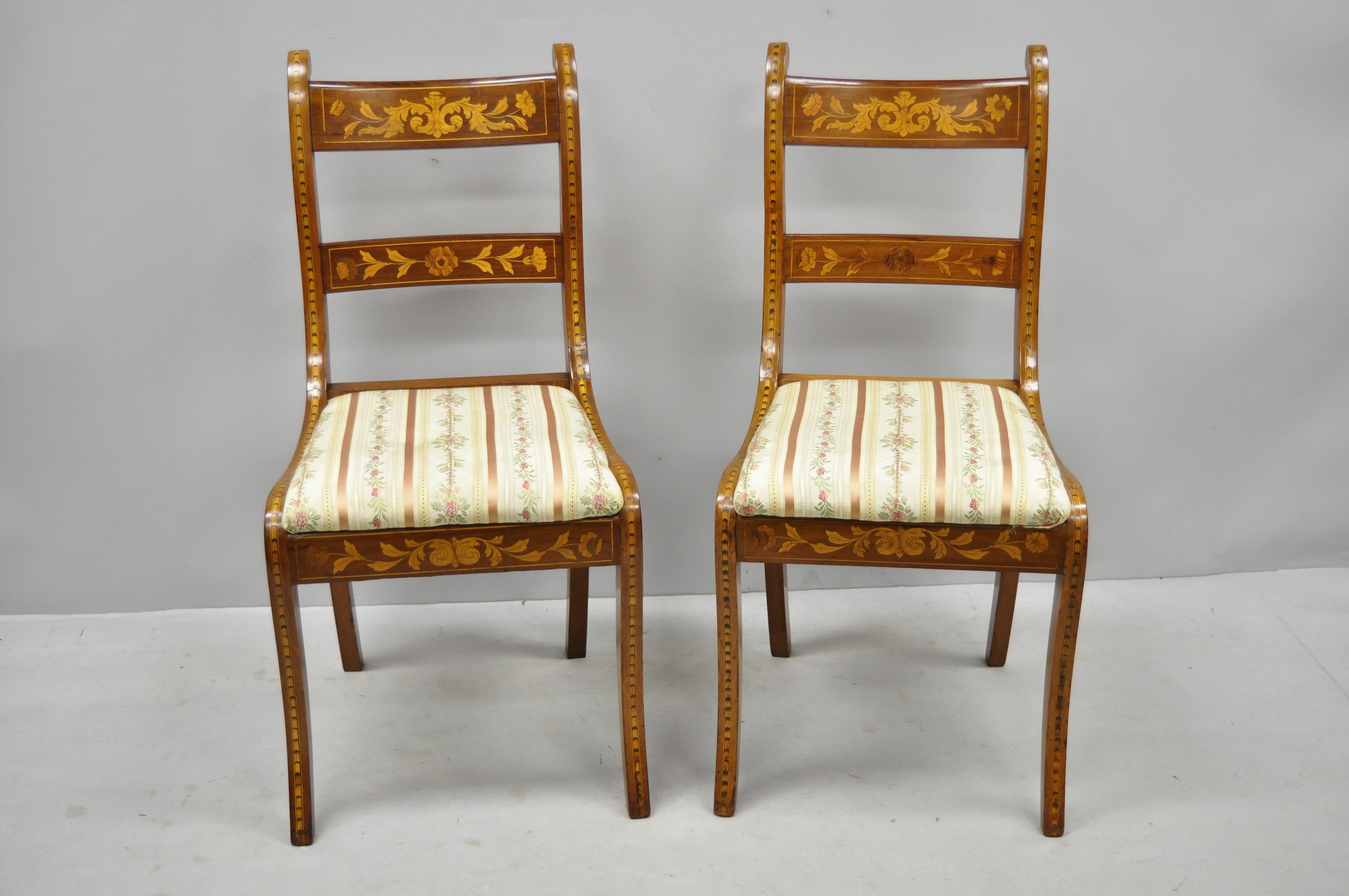 Pair of 19th century satinwood Dutch marquetry inlay Regency side chairs. Item features remarkable satinwood floral inlay throughout, solid wood construction, upholstered seat, shapely saber legs, very nice antique item, circa late 19th century.