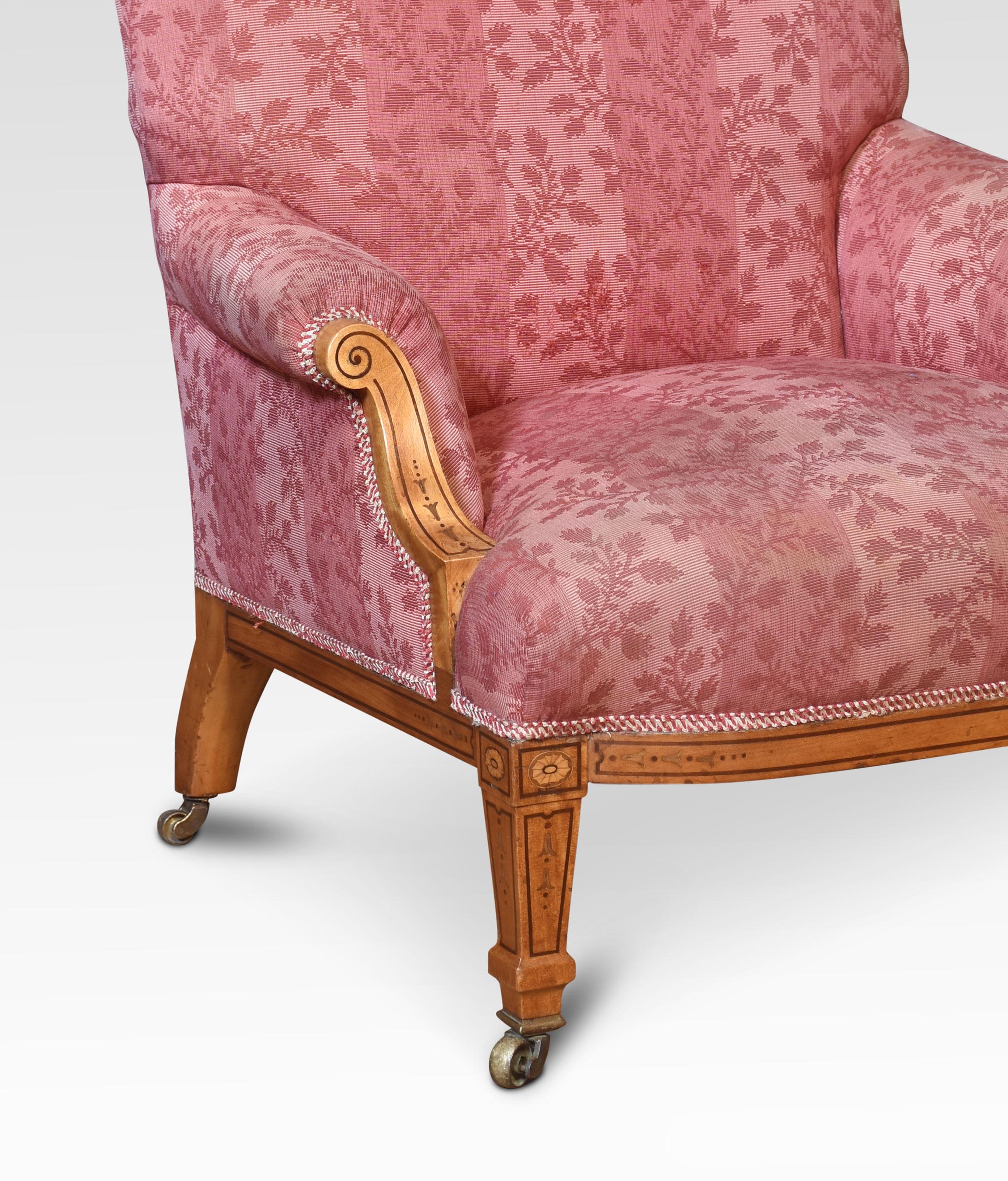 Pair of 19th-century graduated satinwood Lounge chairs, the shaped backs and overstuffed scrolling arms and seat upholstered in damask, the Upholstery is worn with some marks. Raised up on satinwood frame with inlaid detail terminating in brass