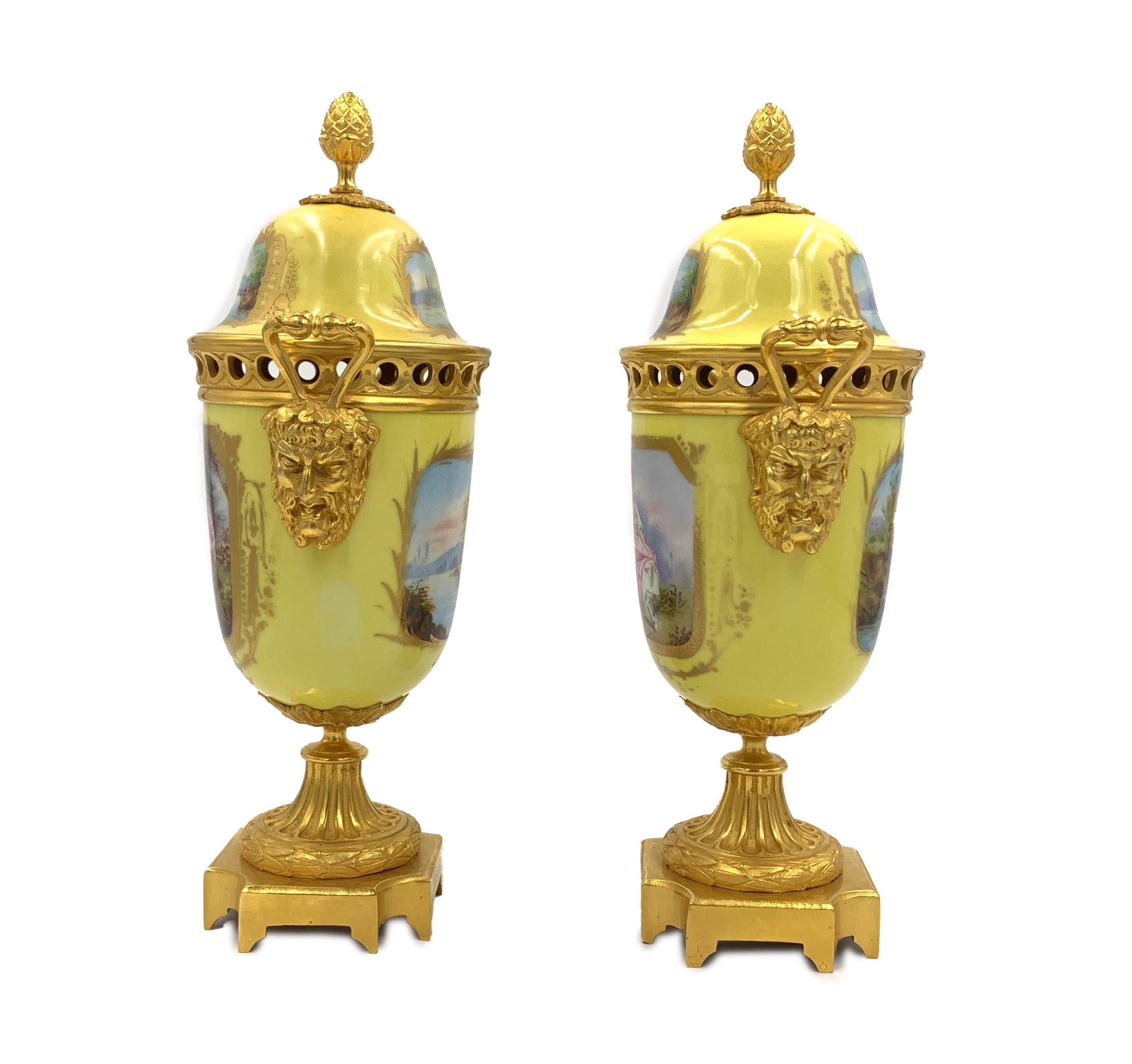 Pair of 19th century Sevres style porcelain and gilt metal vases, the front of the vases decorated with romantic scenes while the reverse and the lids decorated with river scenes, Each vase stands on a square ormolu base.
 