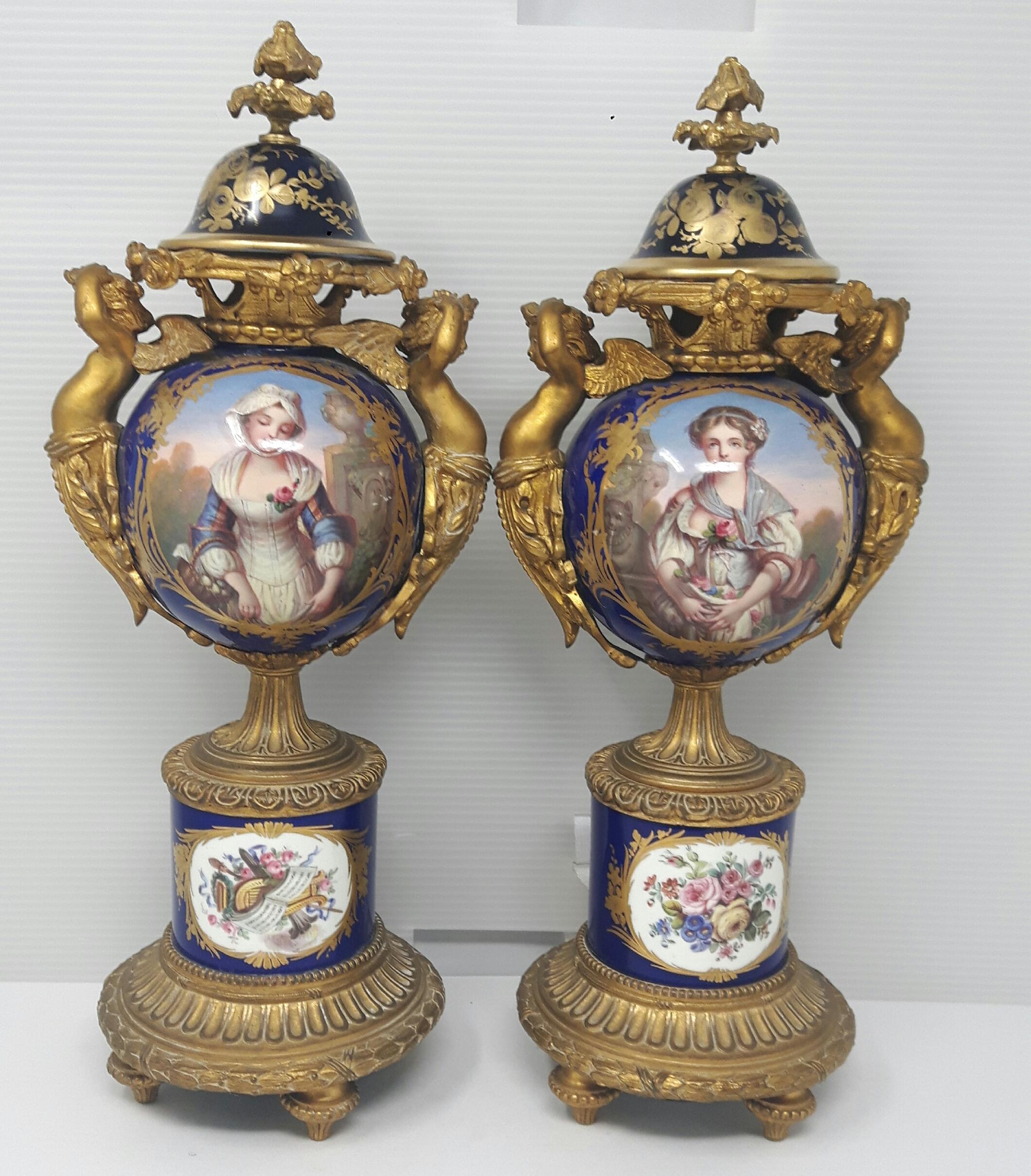 A pair of Sèvres-style vases painted with cartouches after Jean-Baptiste Greuze representing chastity and womanhood. The body of the vases is encased by an extremely high quality of gilt bronze cupidons or winged cupids and Rococo bases all in the
