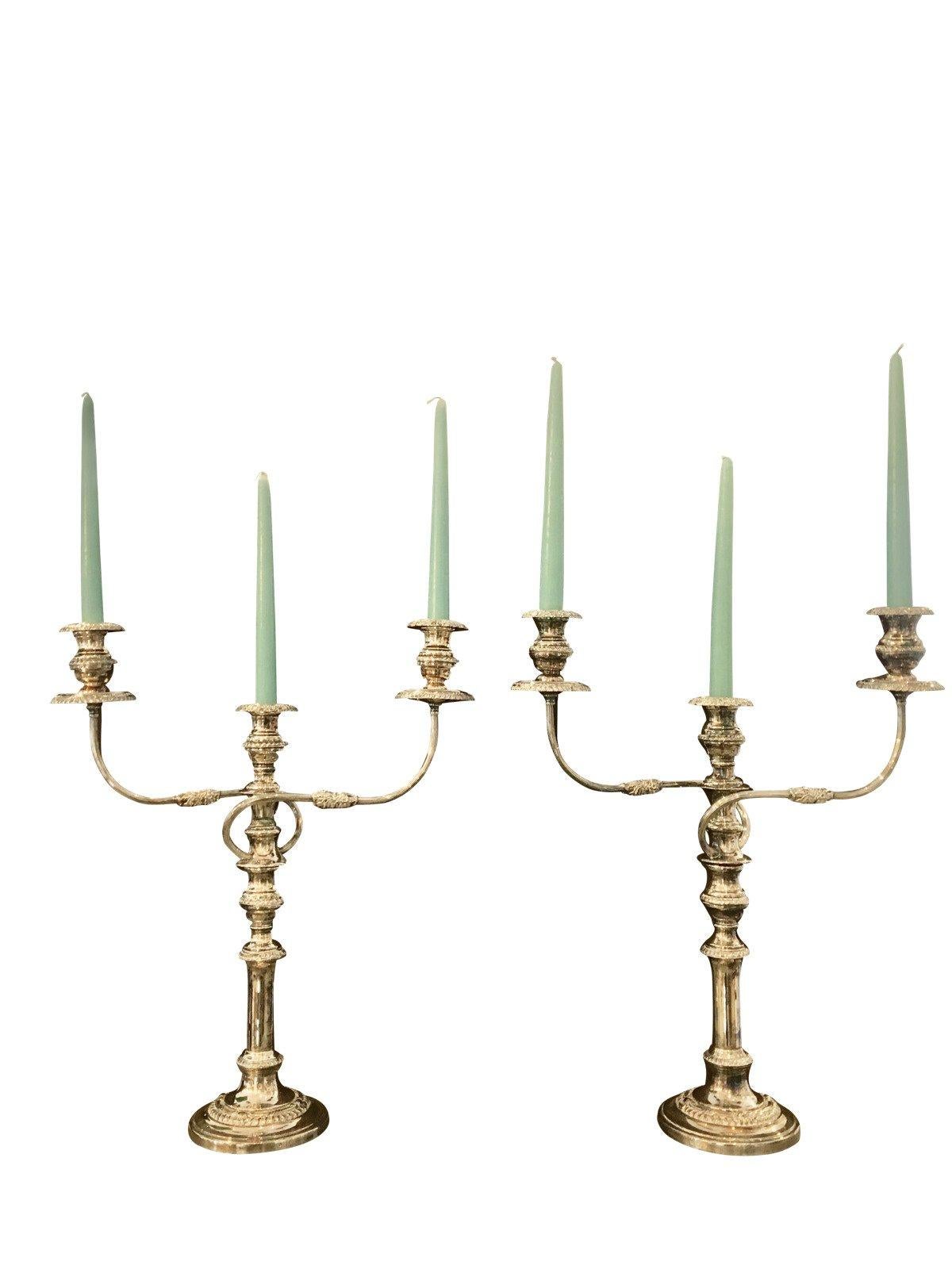 Pair of English 19th century Sheffield plate candelabra, each in two parts, with gadrooning, three lights and flame finials.