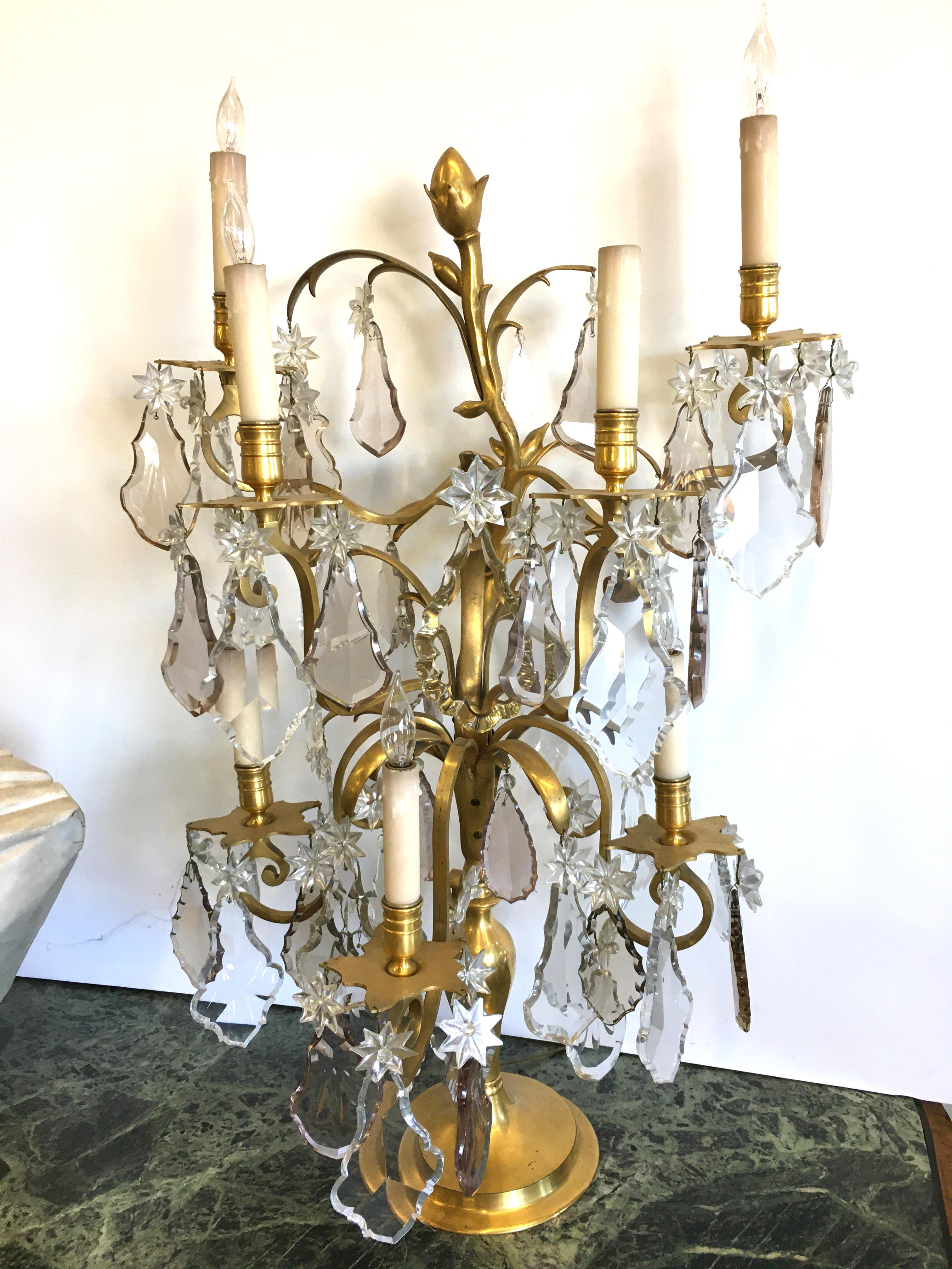 Outstanding pair of large signed Jansen bronze doré girondoles with multicolored and faceted Baccarat crystals. These girondoles have a highly stylized form with seven tiered newly electrified candlelights. They are very decorative and have the