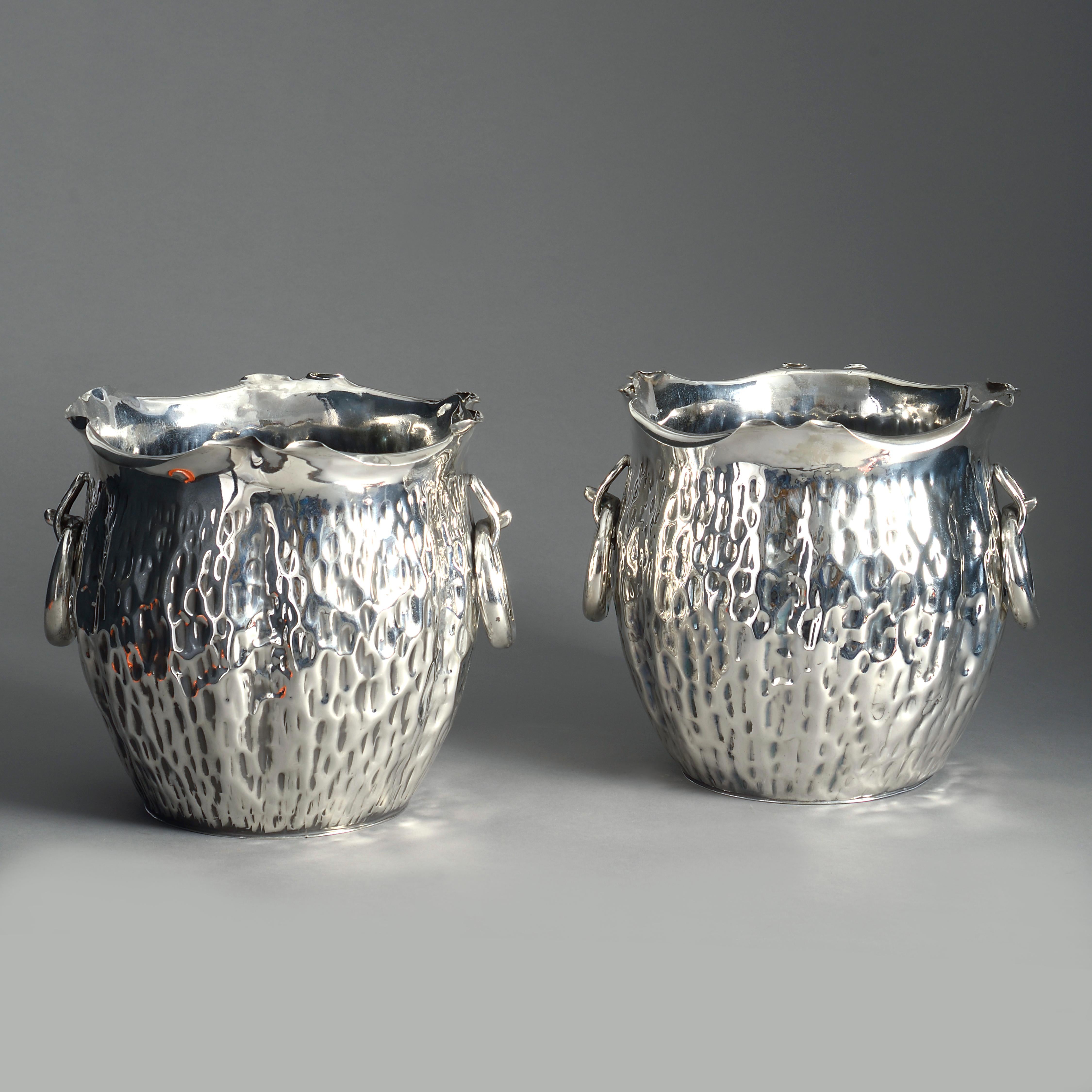 A pair of late 19th century silver plated planters or wine coolers, naturalistically modelled as tree bark and retaining the original ring handles.

With makers stamps for Hukin & Heath to the underside.