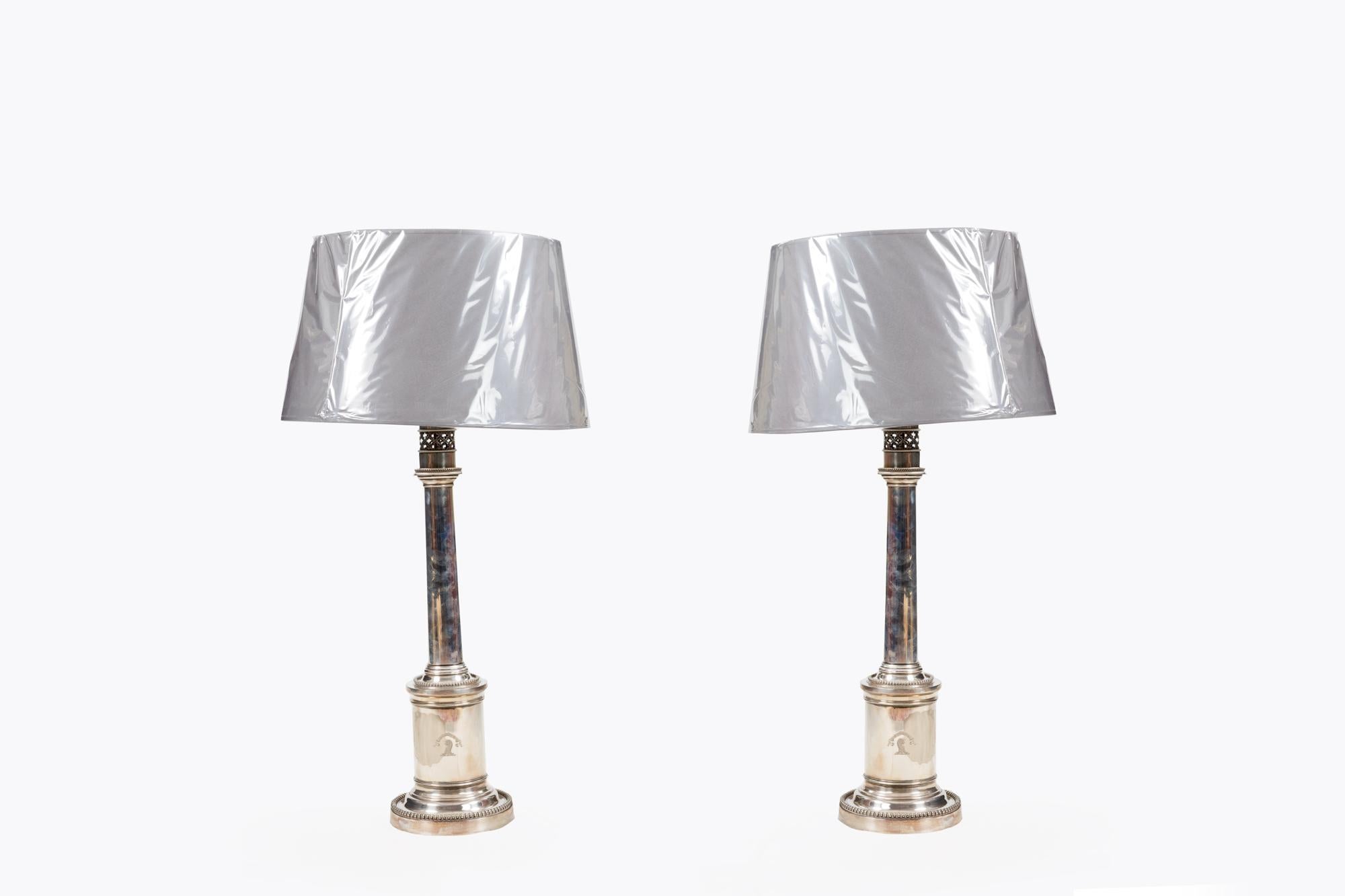 Pair of 19th Century, silver-plated lamps. Featuring a doric column shaft on a circular beaded pedestal and stepped cylindrical beaded base.